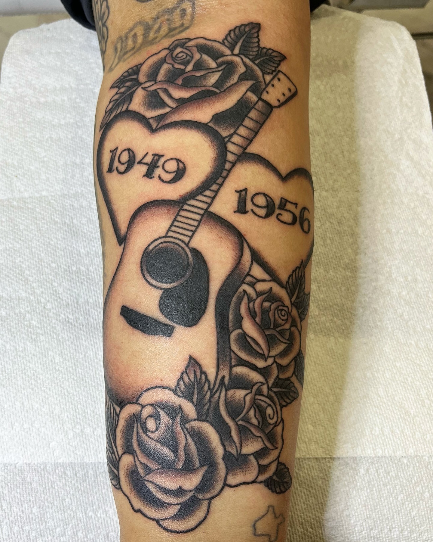 Guitar and roses American traditional tattoo on the forearm by Pedroux M.