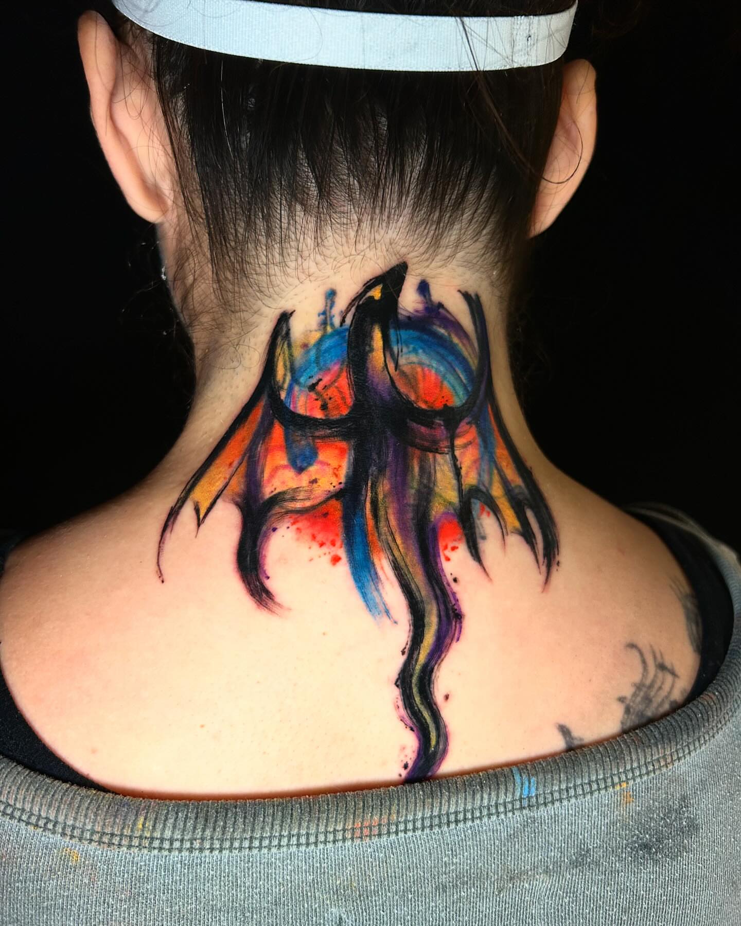 Abstract flame watercolor tattoo on the neck by ⠀Joey Rosado