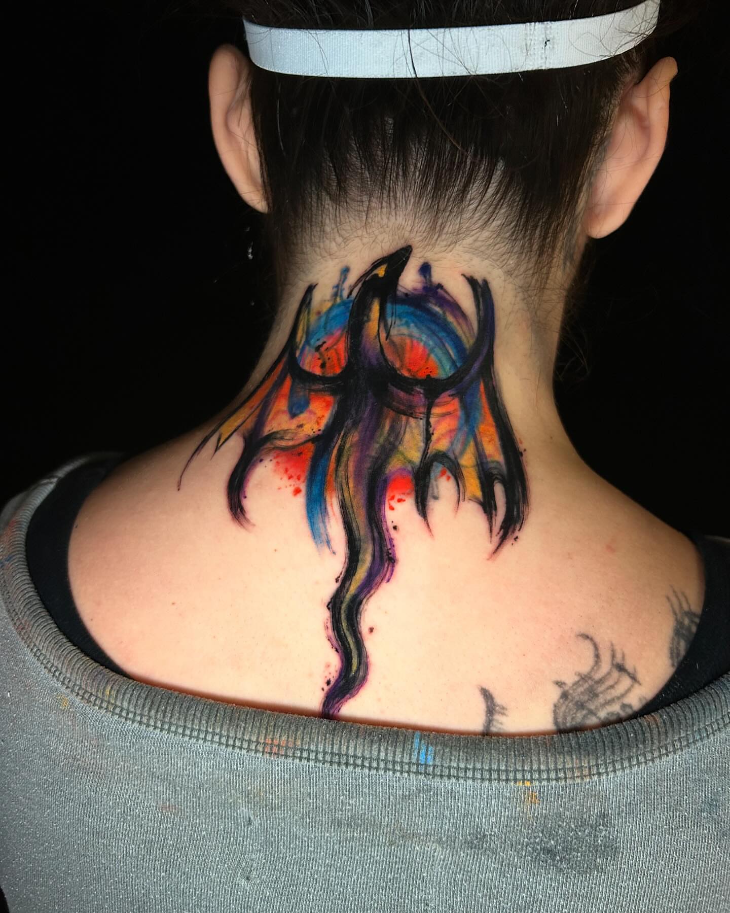 Abstract design watercolor tattoo on the neck by ⠀Joey Rosado
