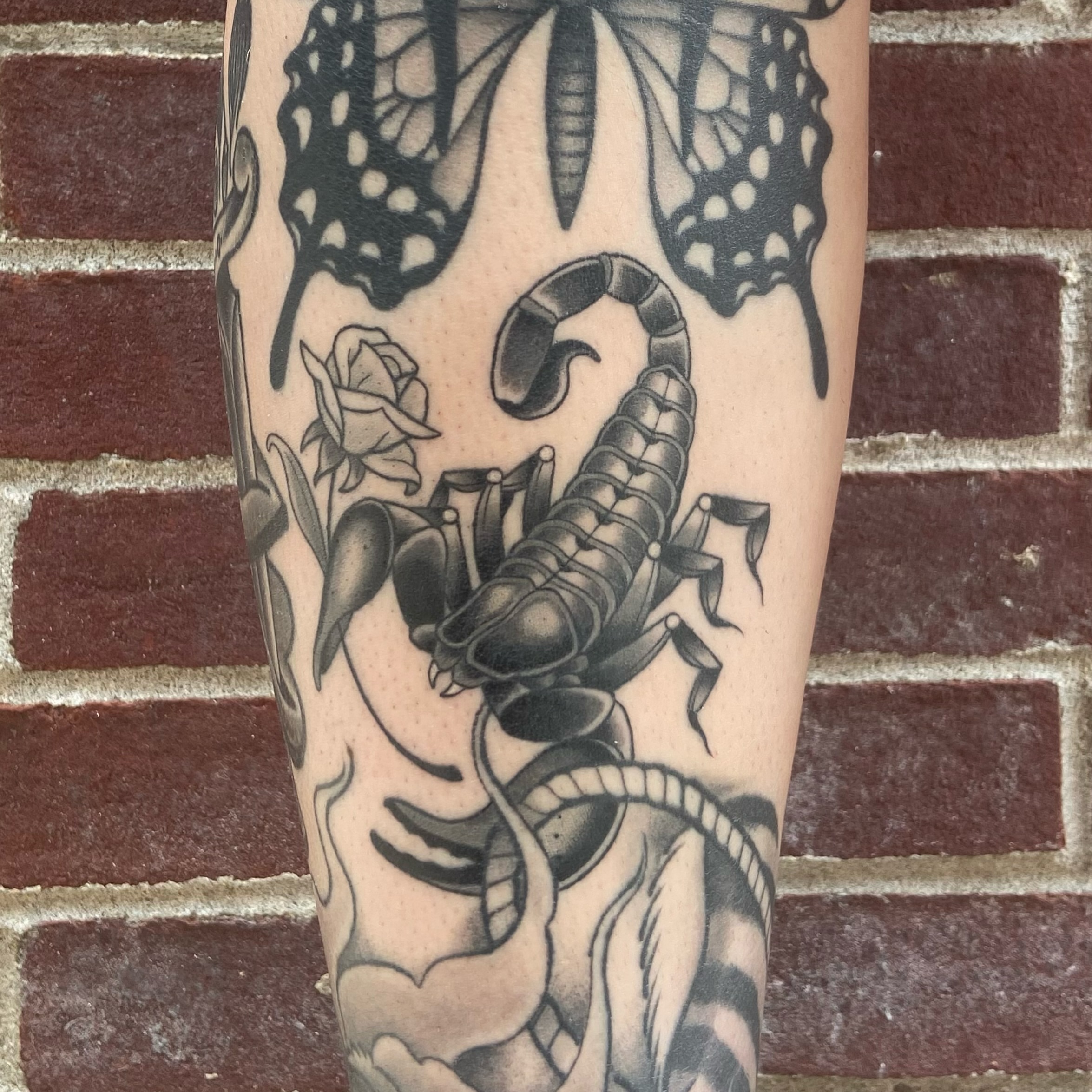 Scorpion and butterflies American traditional tattoo on the forearm by Alicia