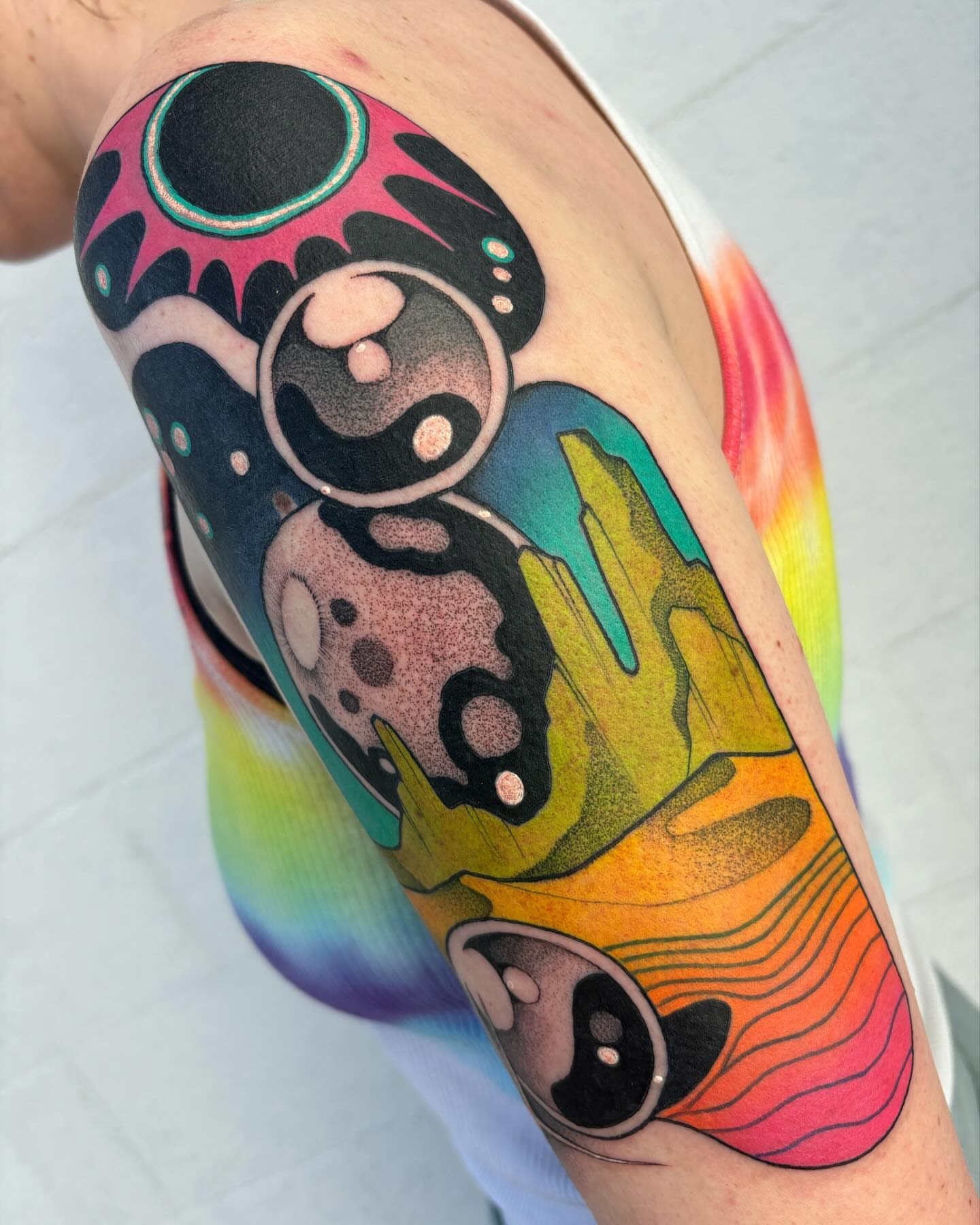 Abstract space dotwork tattoo on the forearm by Carly Zehring