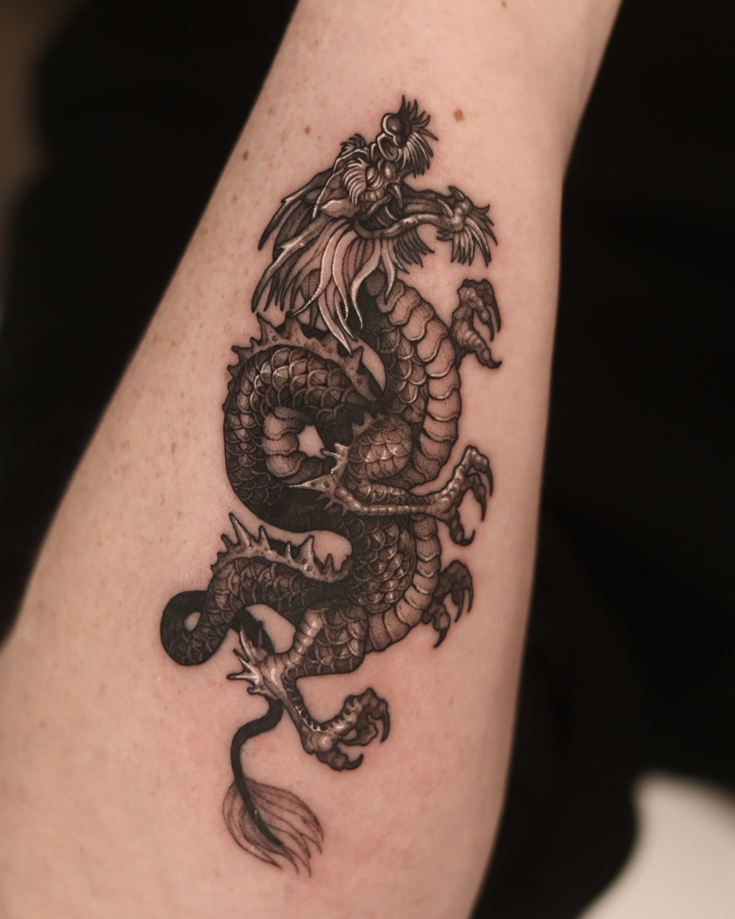 Dragon realism tattoo on the forearm by Blackwork A P S O