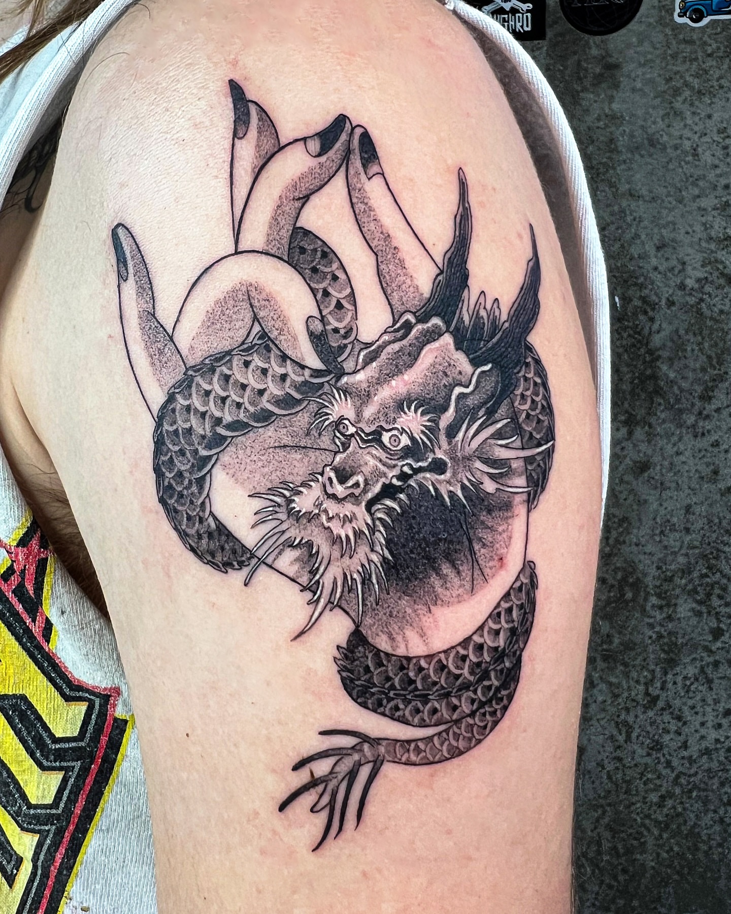Dragon black and grey tattoo on the shoulder by Swani
