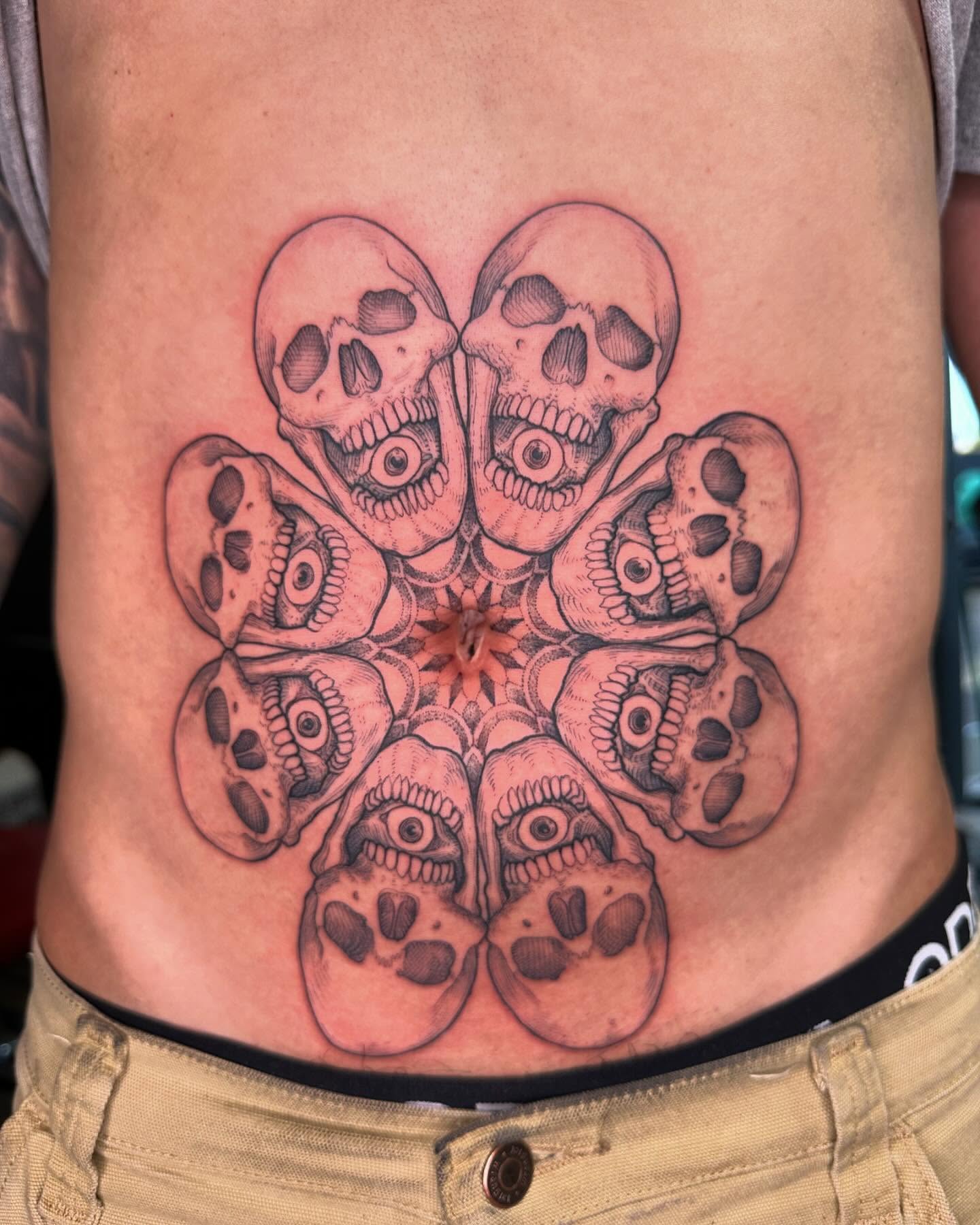 Skulls geometric tattoo on the torso by Landon Morgan