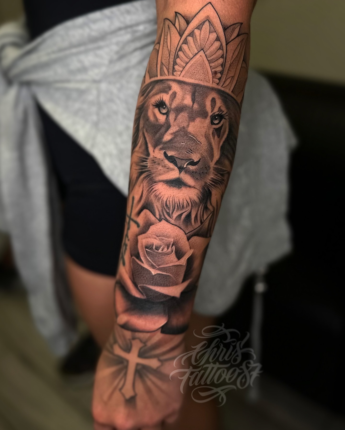 Lion with crown realism tattoo on the forearm by chris tattoo
