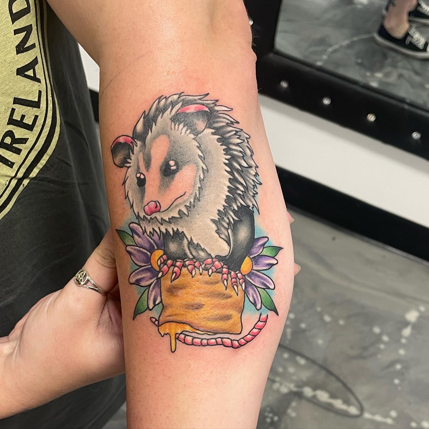 Possum with flowers realism tattoo on the forearm by Brandon Anderson