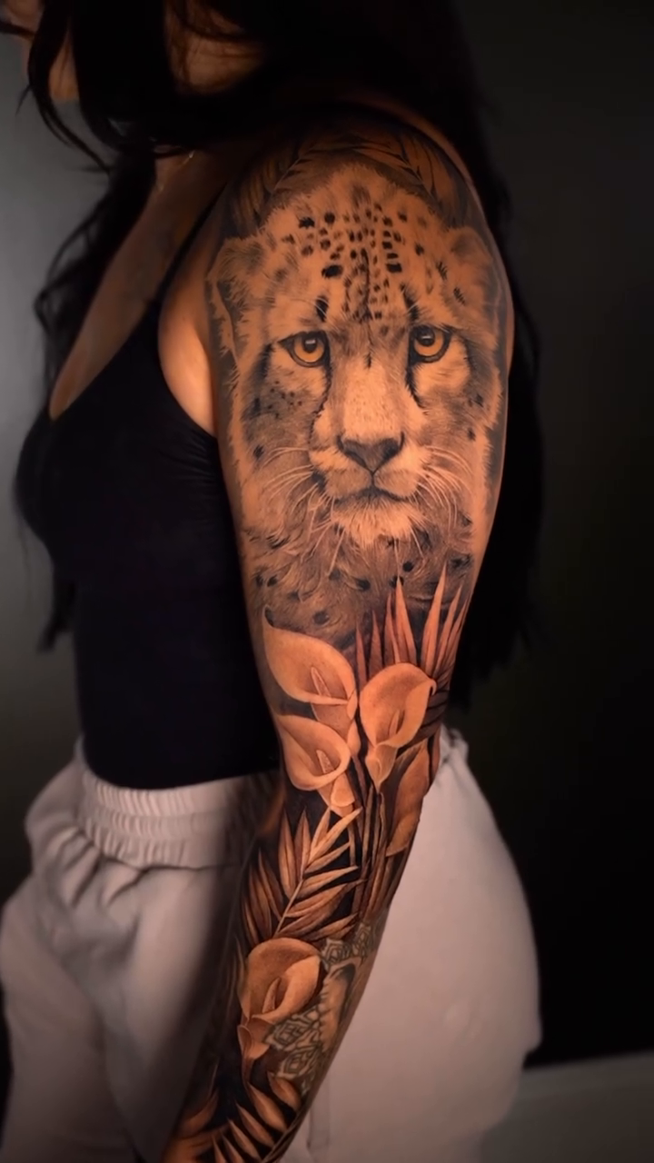 Cheetah and tropical leaves realism tattoo by Risa