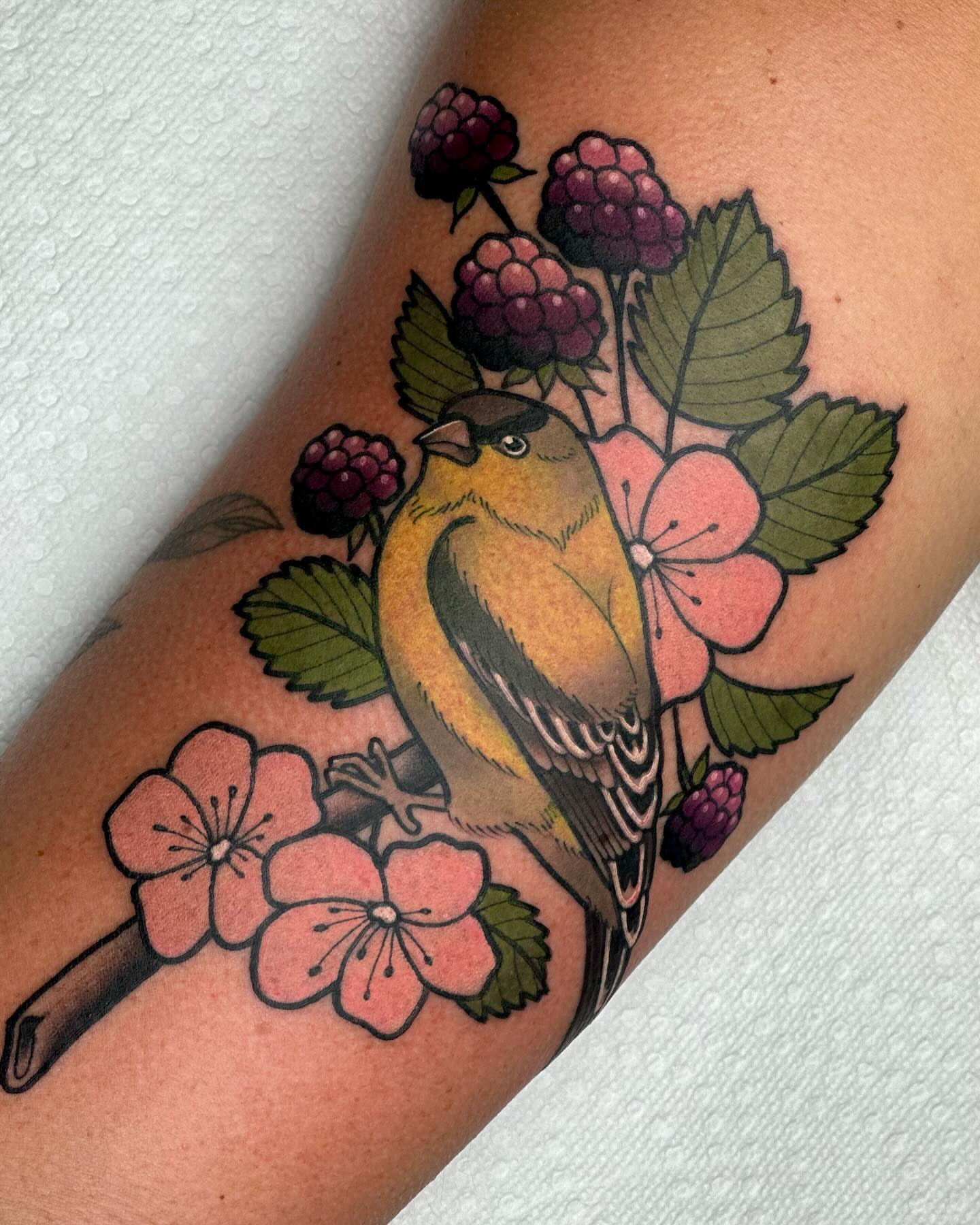 Bird and flowers American traditional tattoo on the forearm by Katie Kelley