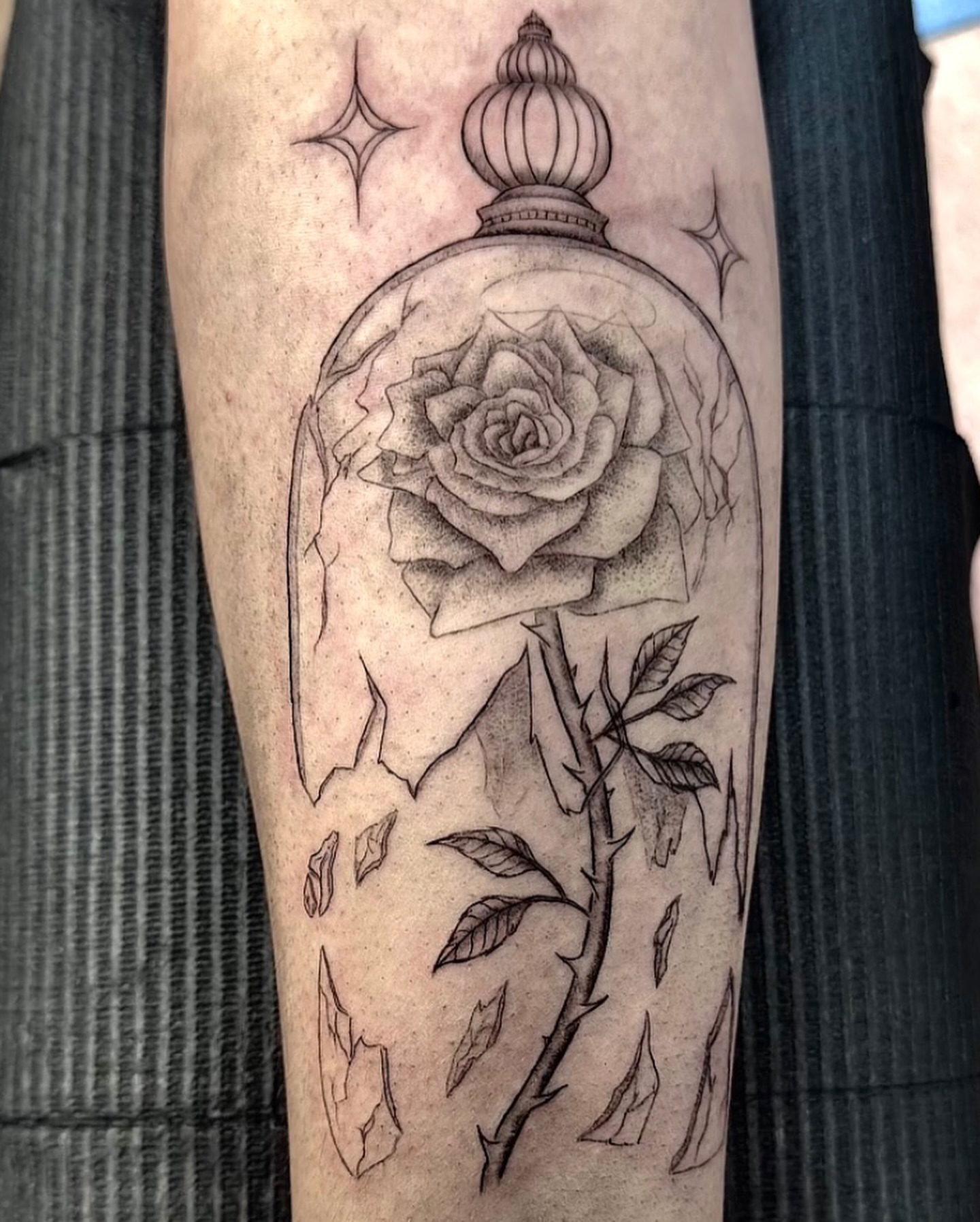 Rose under glass realism tattoo on the forearm by Mika