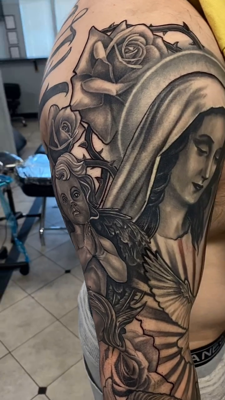 Woman and cherub realism tattoo by Eduardo Gomez