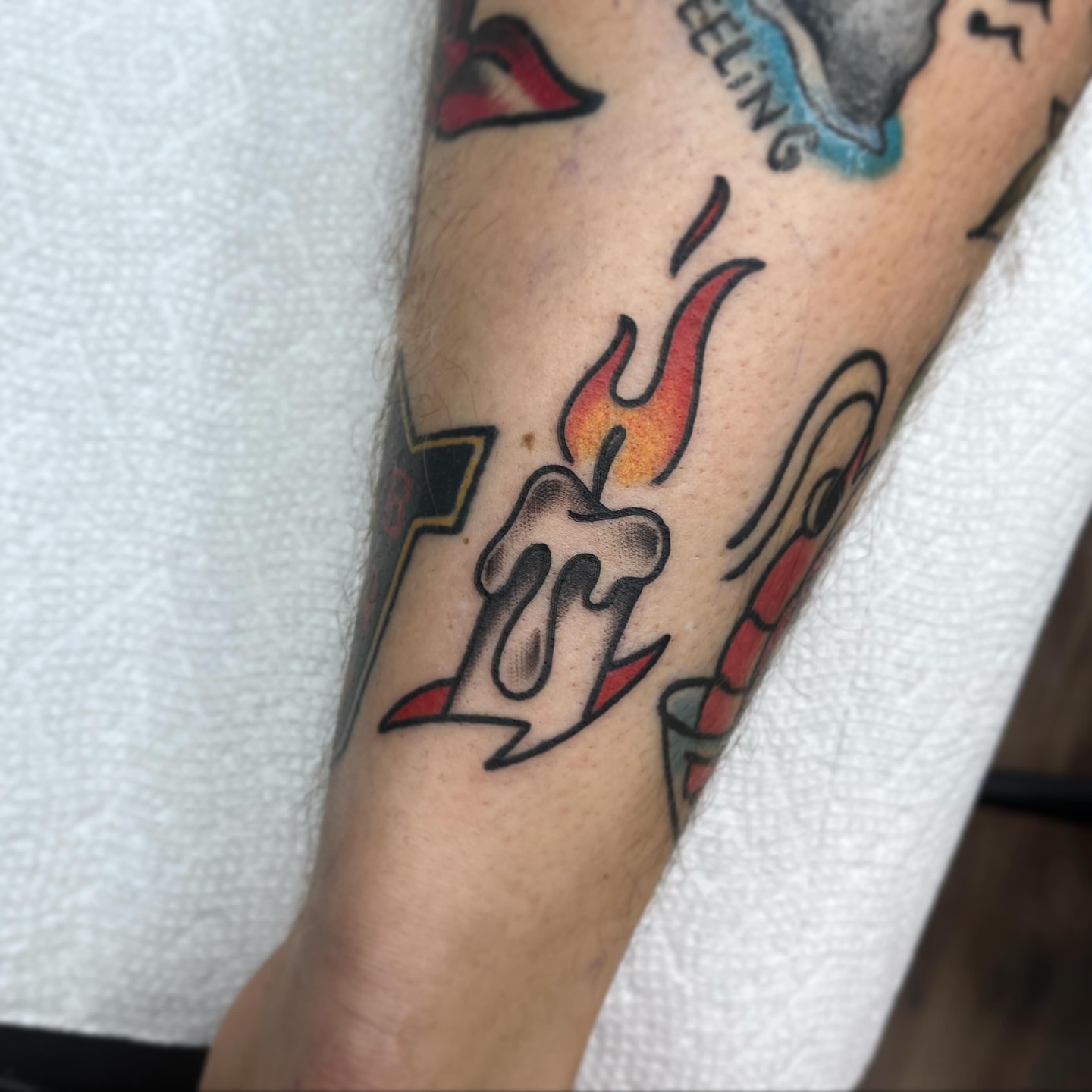 Flame and candle American traditional tattoo on the forearm by Waylen Foster