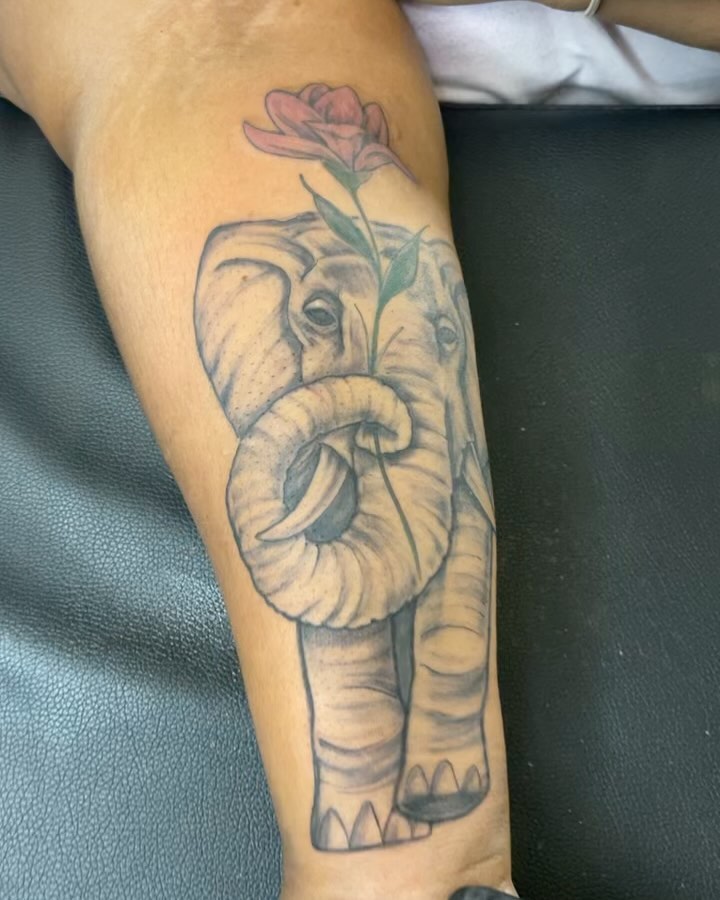 Elephant with rose realism tattoo on the forearm by Azaan (Zanye), Birmingham, Alabama