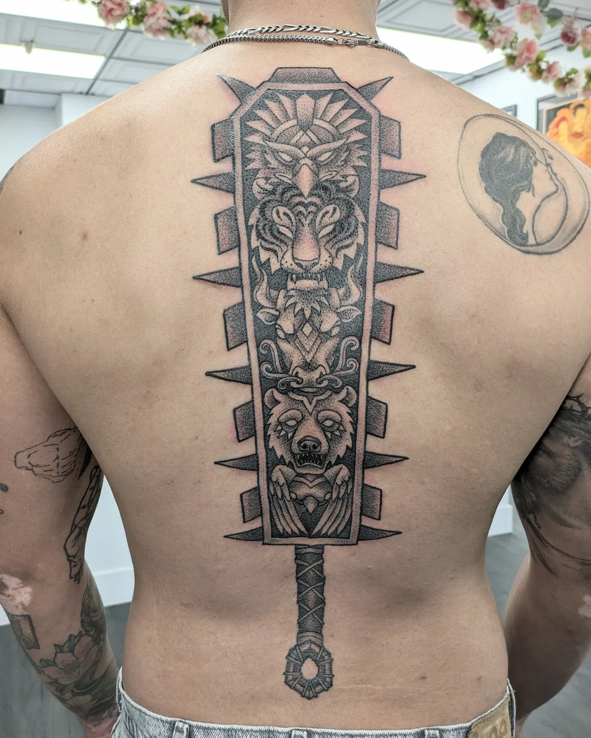 Sword geometric tattoo on the back by Christel Perkins