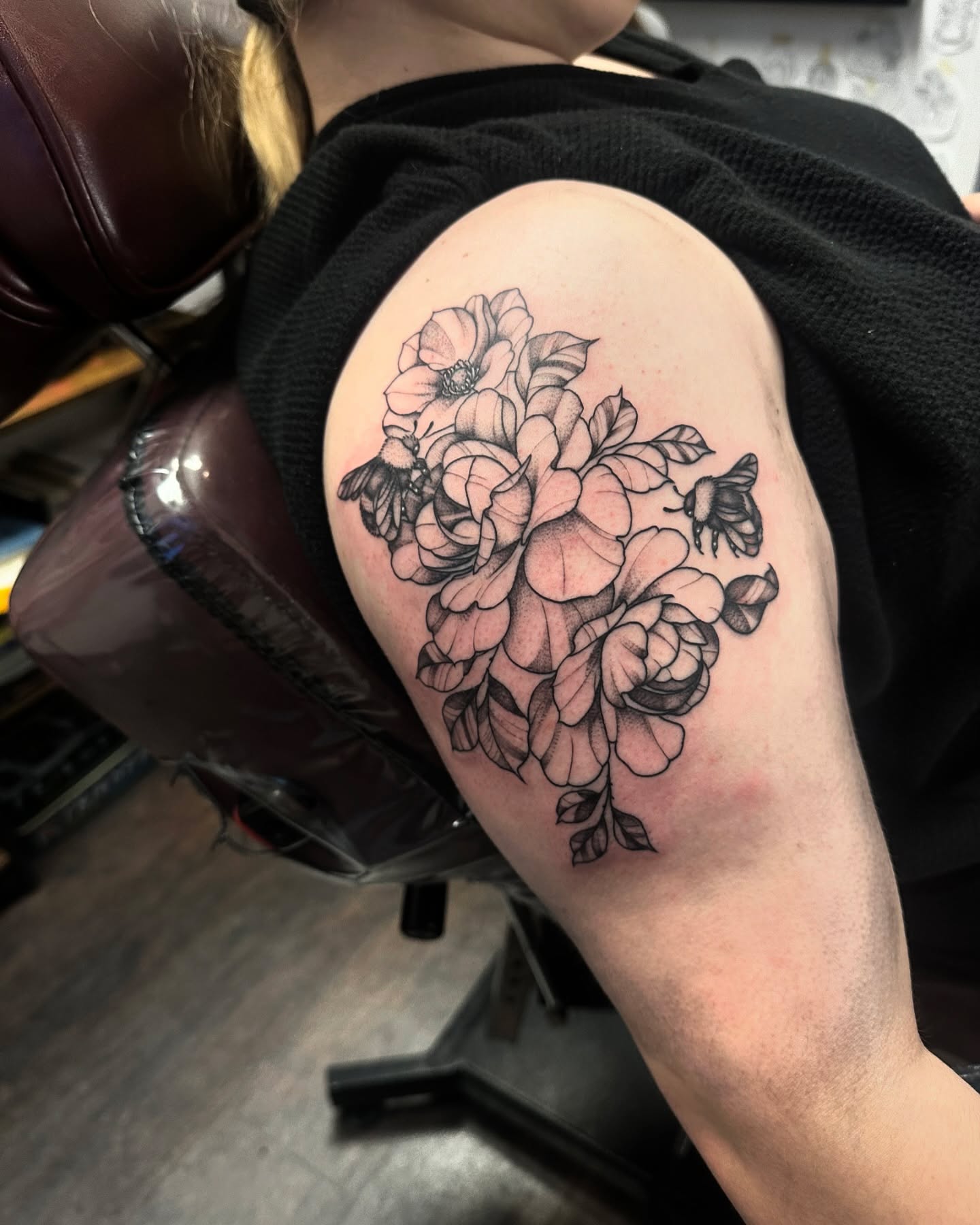 Flower bouquet black and grey tattoo on the shoulder by Kassie Perian