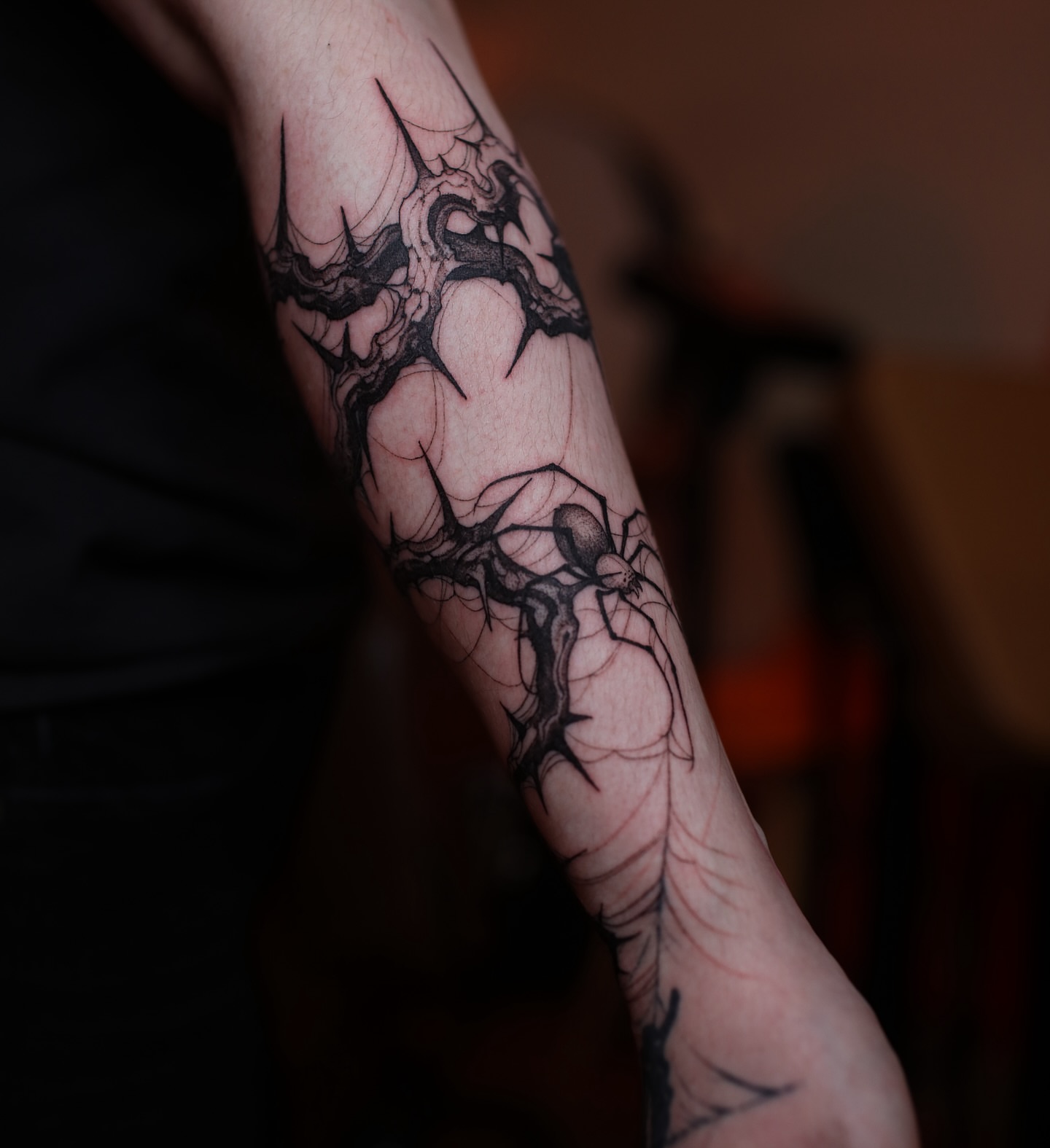 Spider web dark realism tattoo on the forearm by Strokin Konstantin