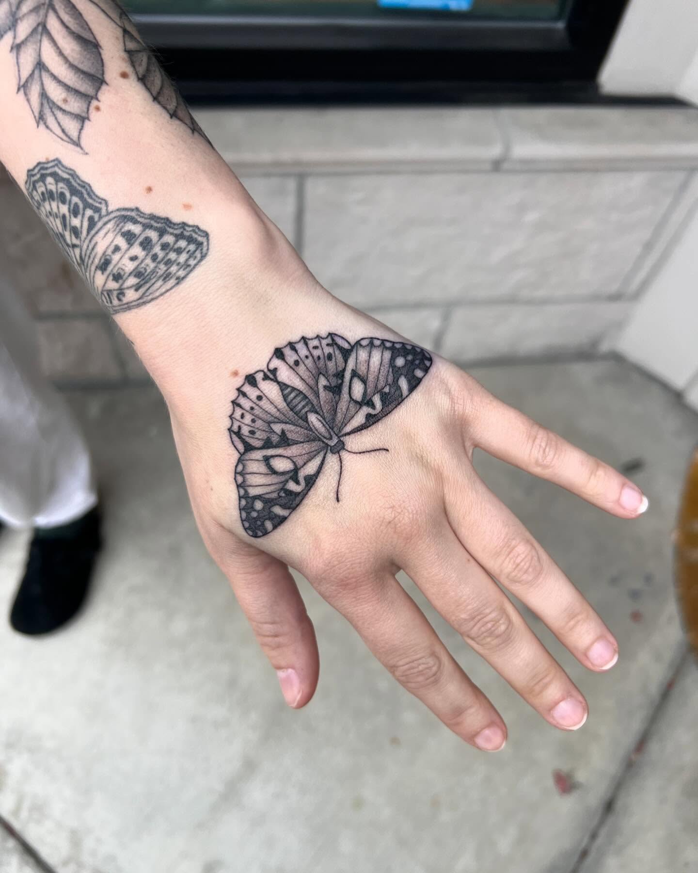 Butterfly black and grey tattoo on the hand by Tasha Venola, Bellingham, Washington