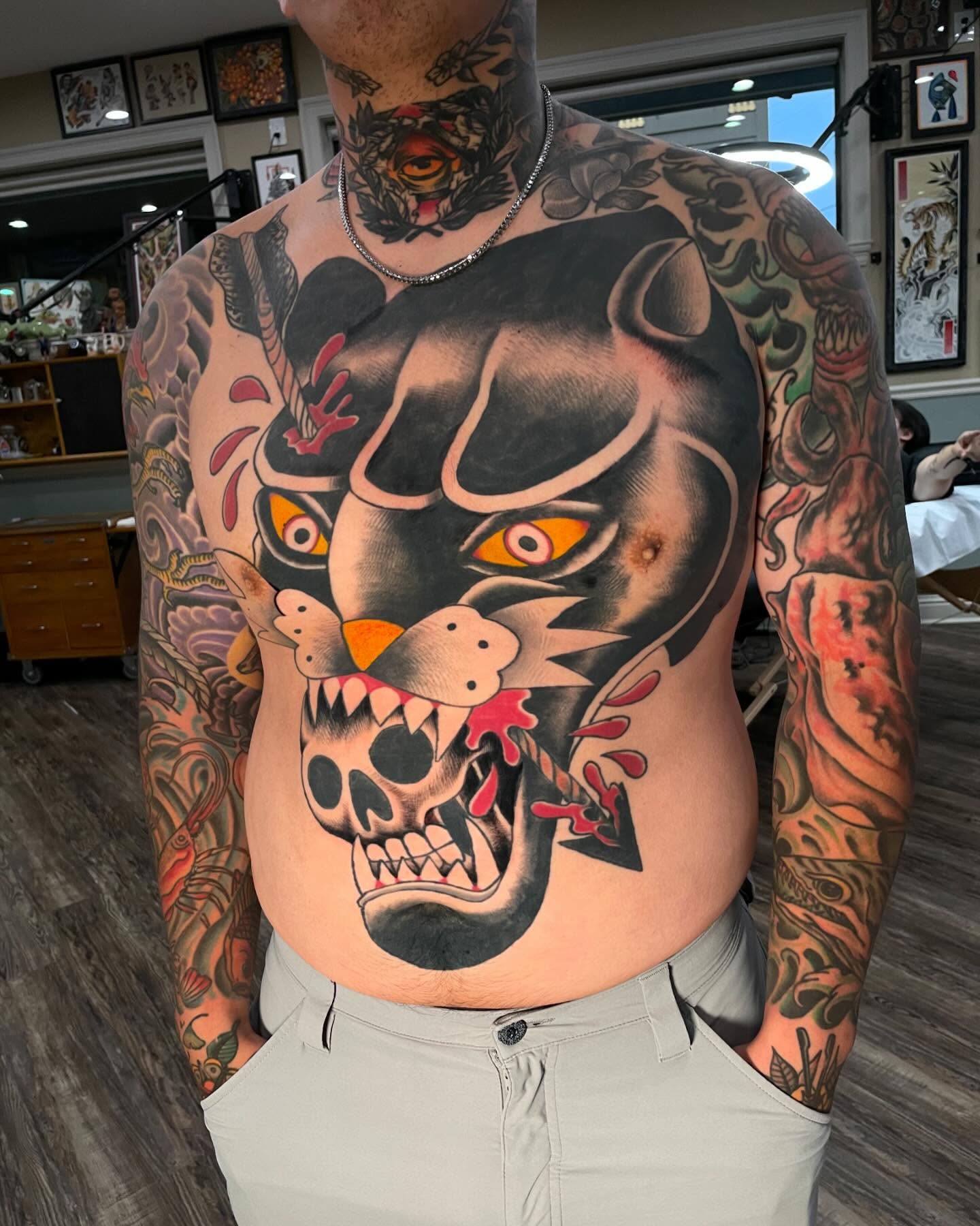 Panther head American traditional tattoo on the torso by Caleb Baker