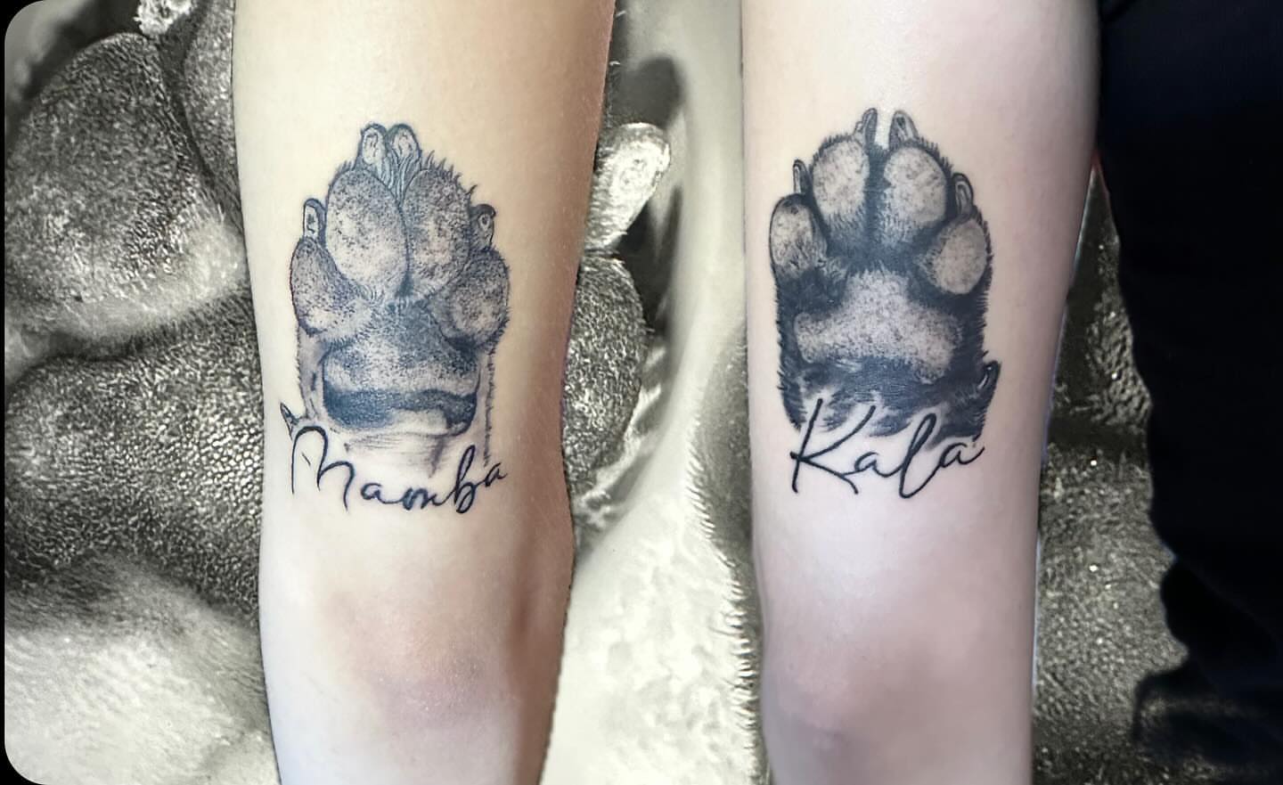 Dog paw prints dotwork tattoo on the forearm by Kunaytattoo