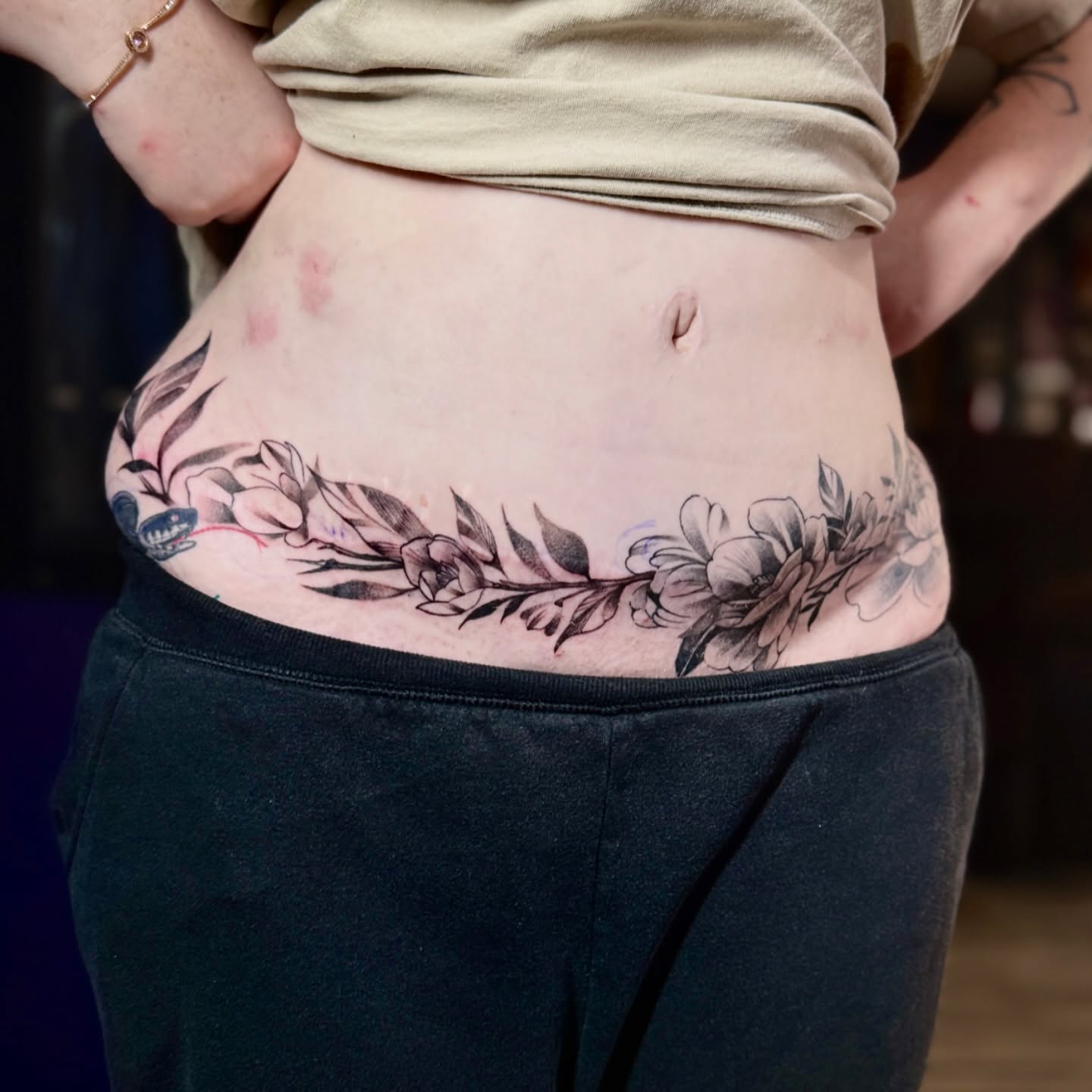 Floral wreath black and grey tattoo on the torso by Steve
