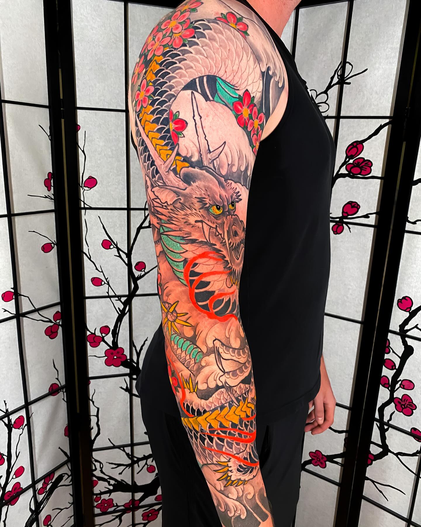 Dragon and cherry blossoms japanese irezumi tattoo on the upper arm by Eric James, Phoenix, Arizona