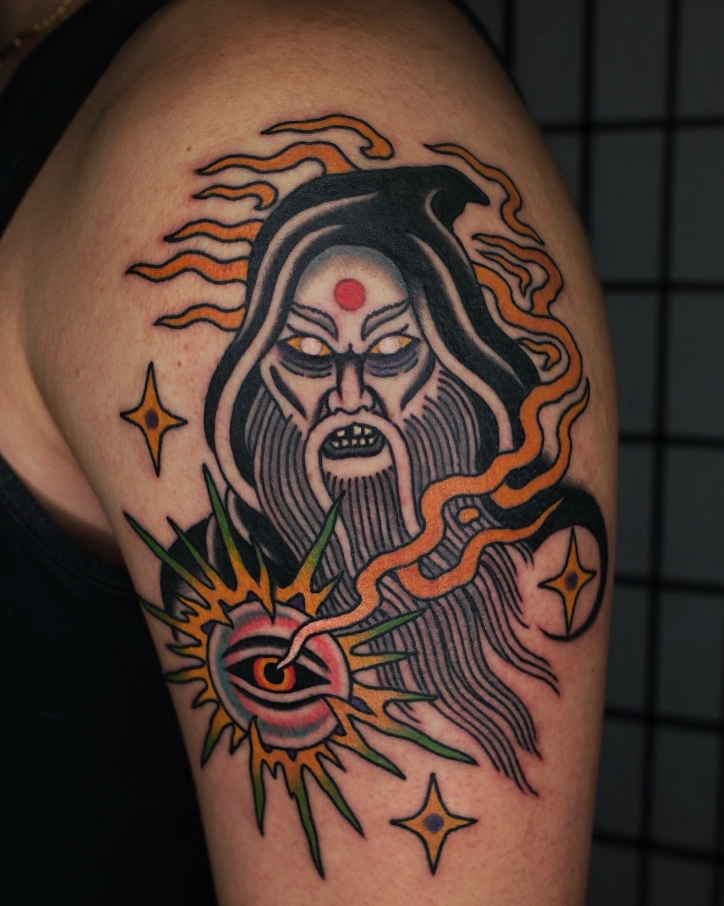 God-like figure American traditional tattoo on the shoulder by Ben Fiedler