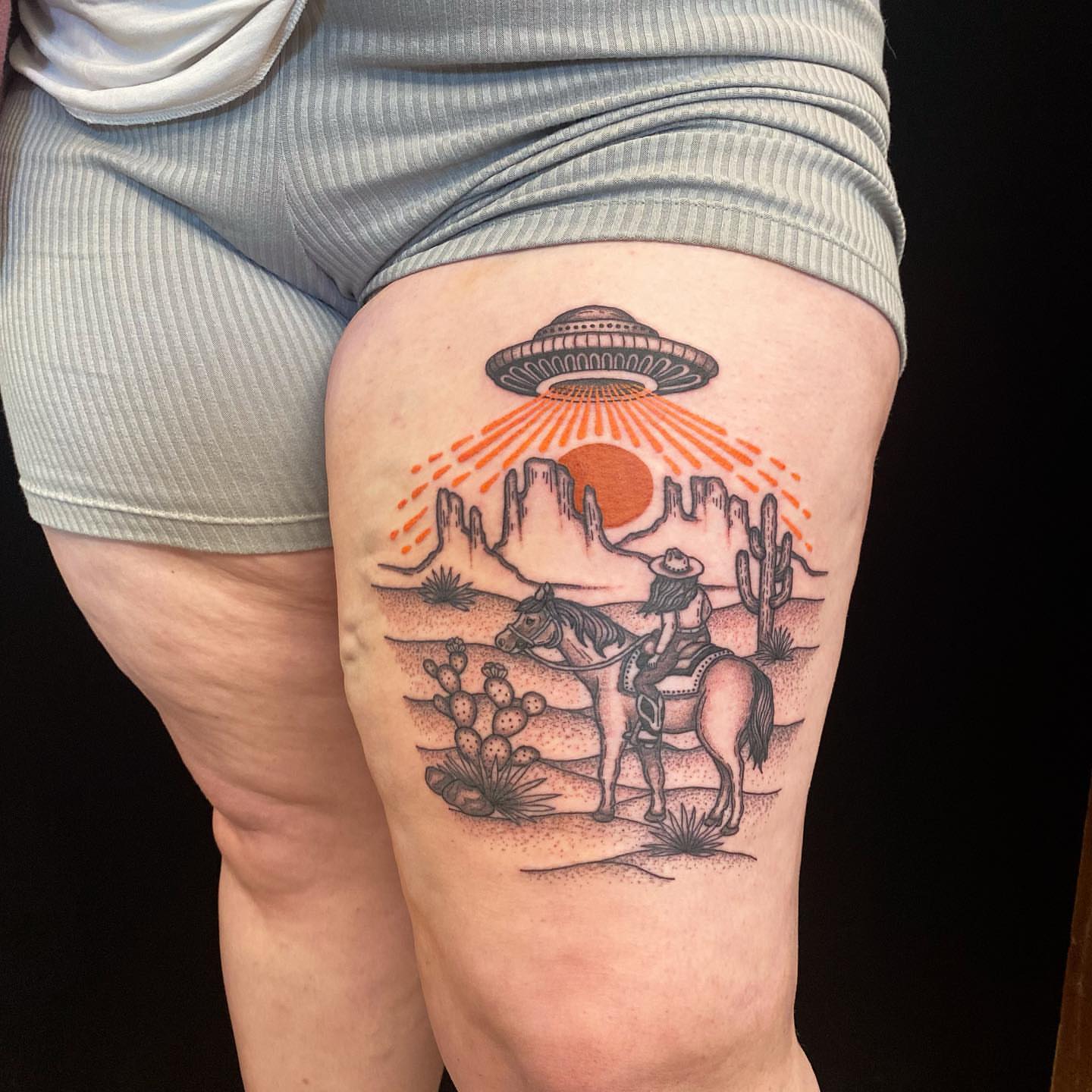 Cowboy on horse with UFO dotwork tattoo on the thigh by Krista - Tattoo Artist