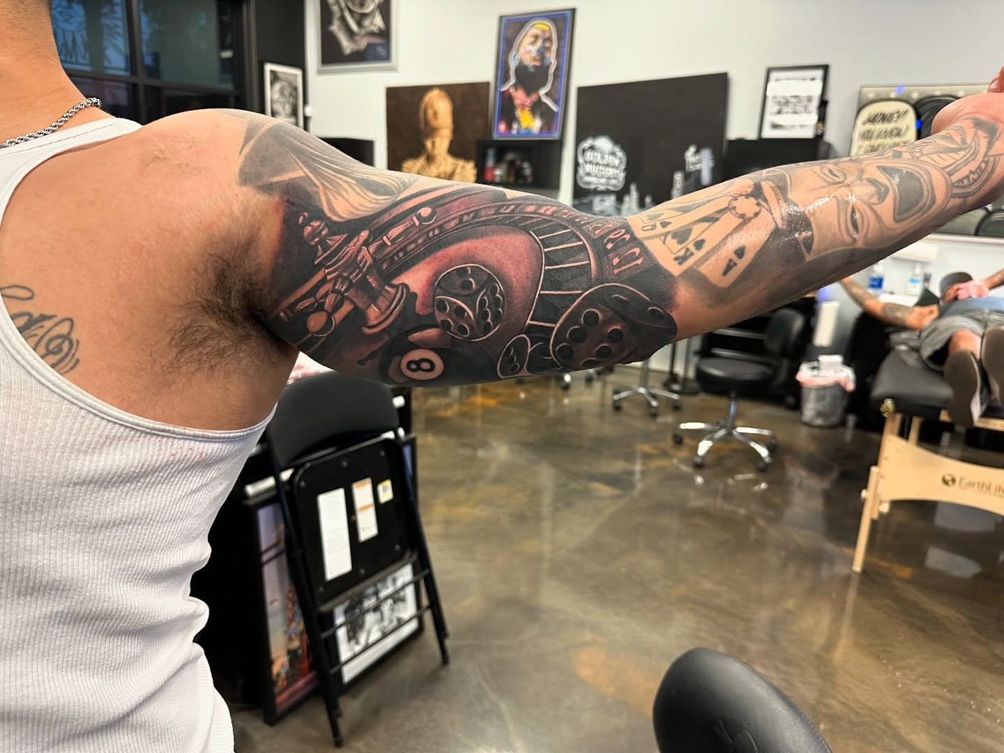 Mechanical gear and playing card realism tattoo on the forearm by Travis