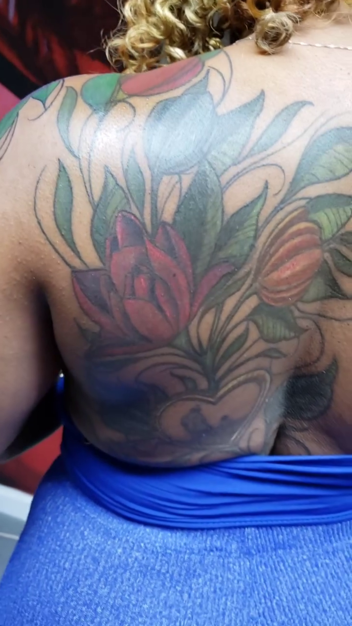 Flowers and leaves realism tattoo by Dannie Blythewood