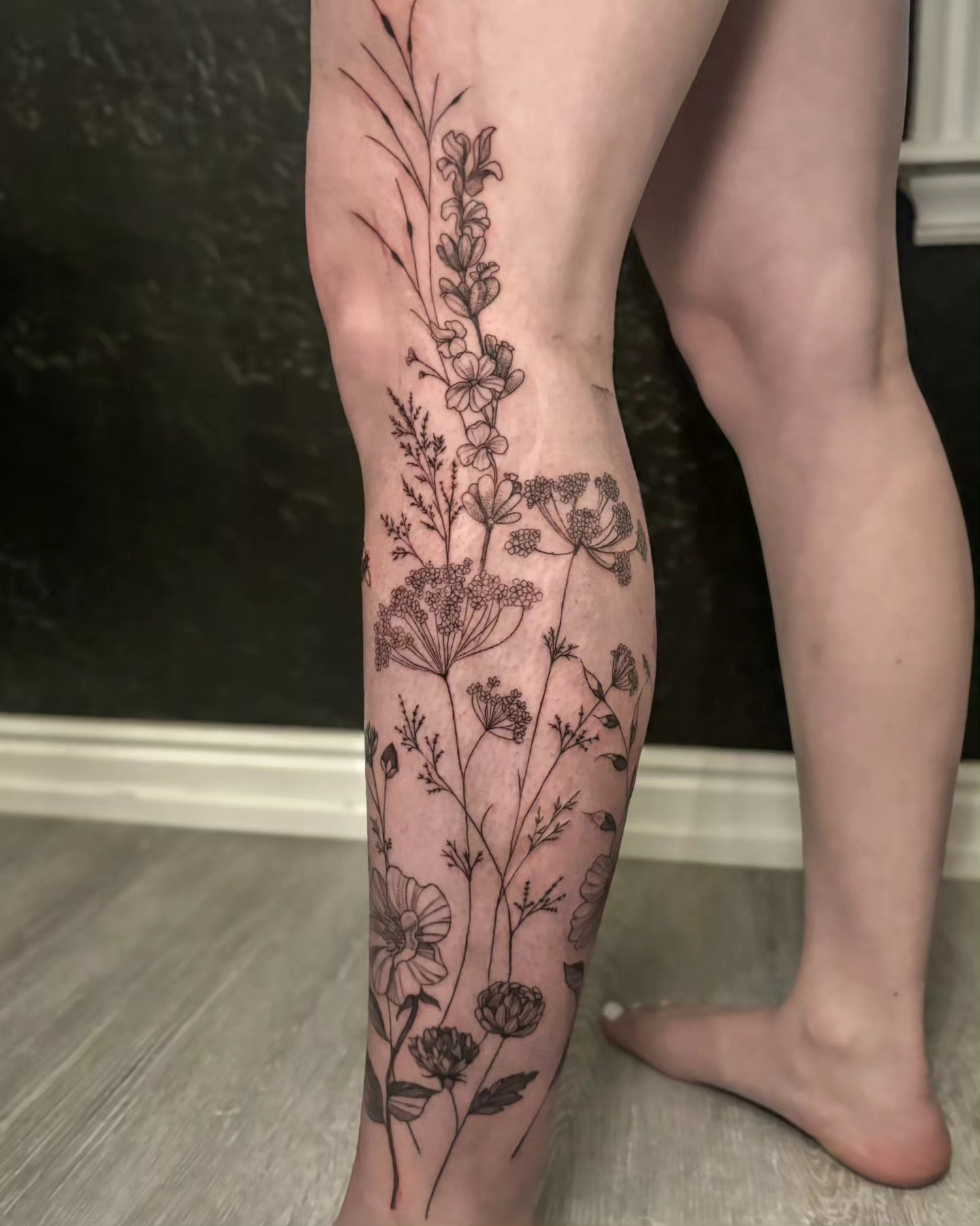 Wildflowers black and grey tattoo on the calf by Utah Tattoo Artist