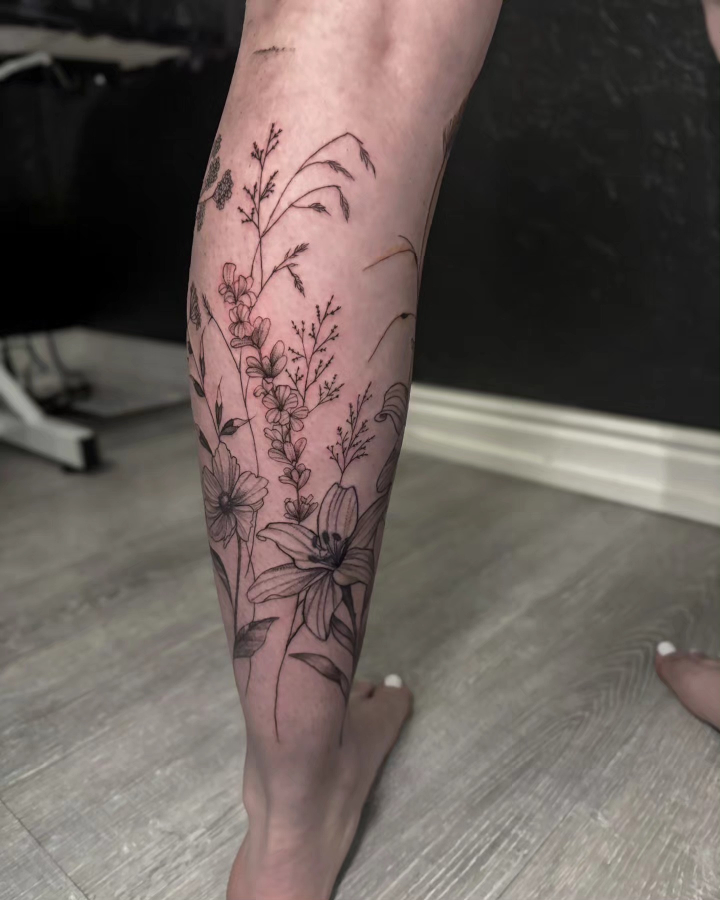 Floral arrangement black and grey tattoo on the calf by Utah Tattoo Artist