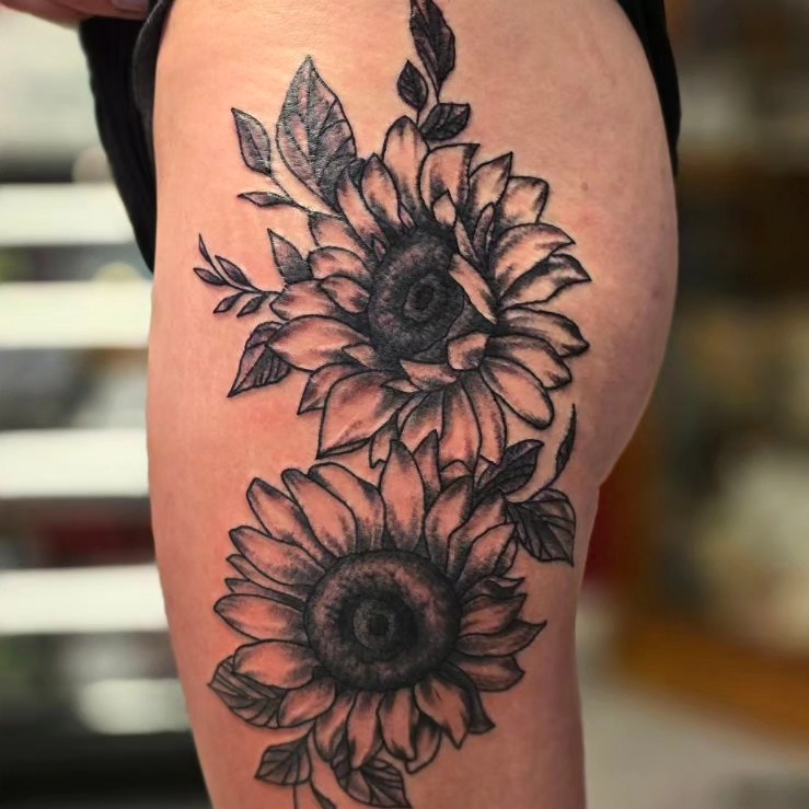 Sunflowers black and grey tattoo on the thigh by Dave Johnson, Billings, Montana