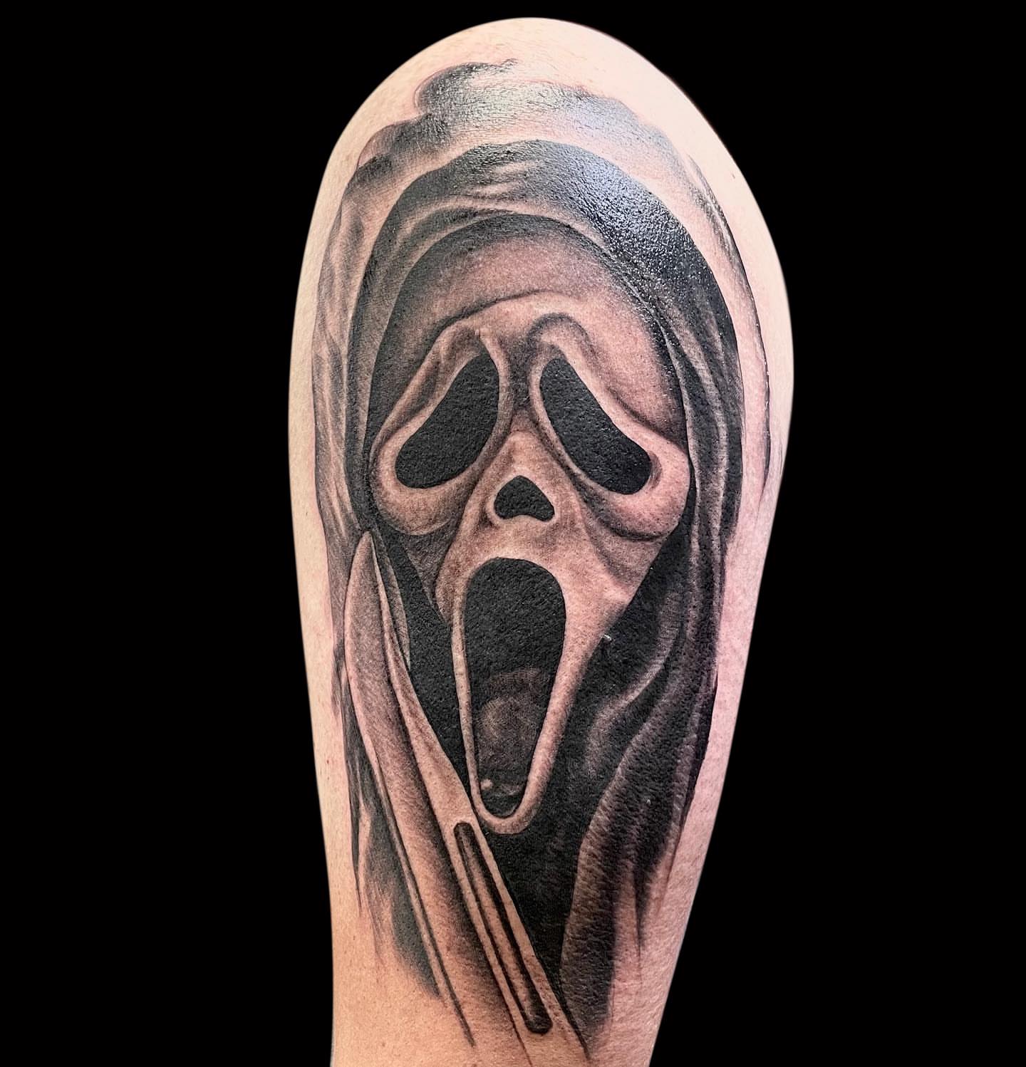 Ghost mask black and grey tattoo on the forearm by Antoinette