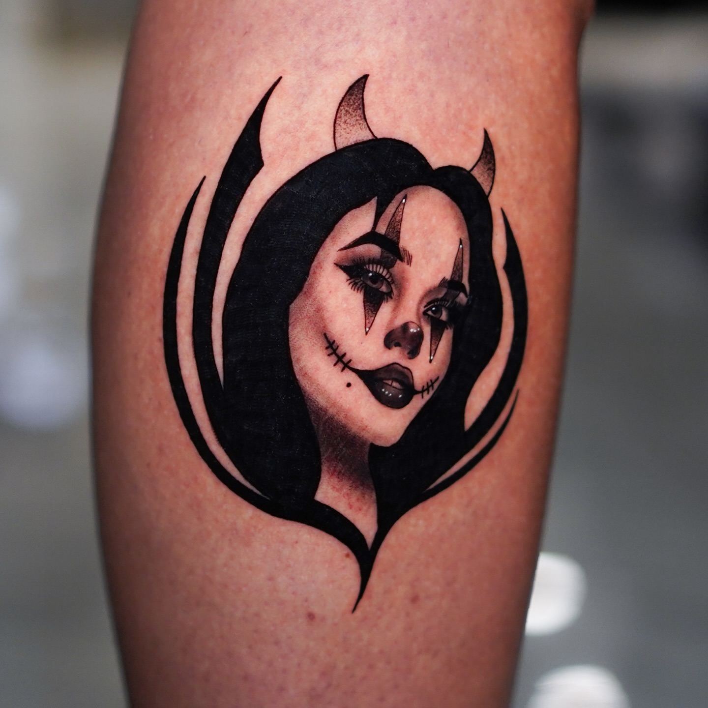 Female face with horns dark realism tattoo on the forearm by Jorden Ruppe