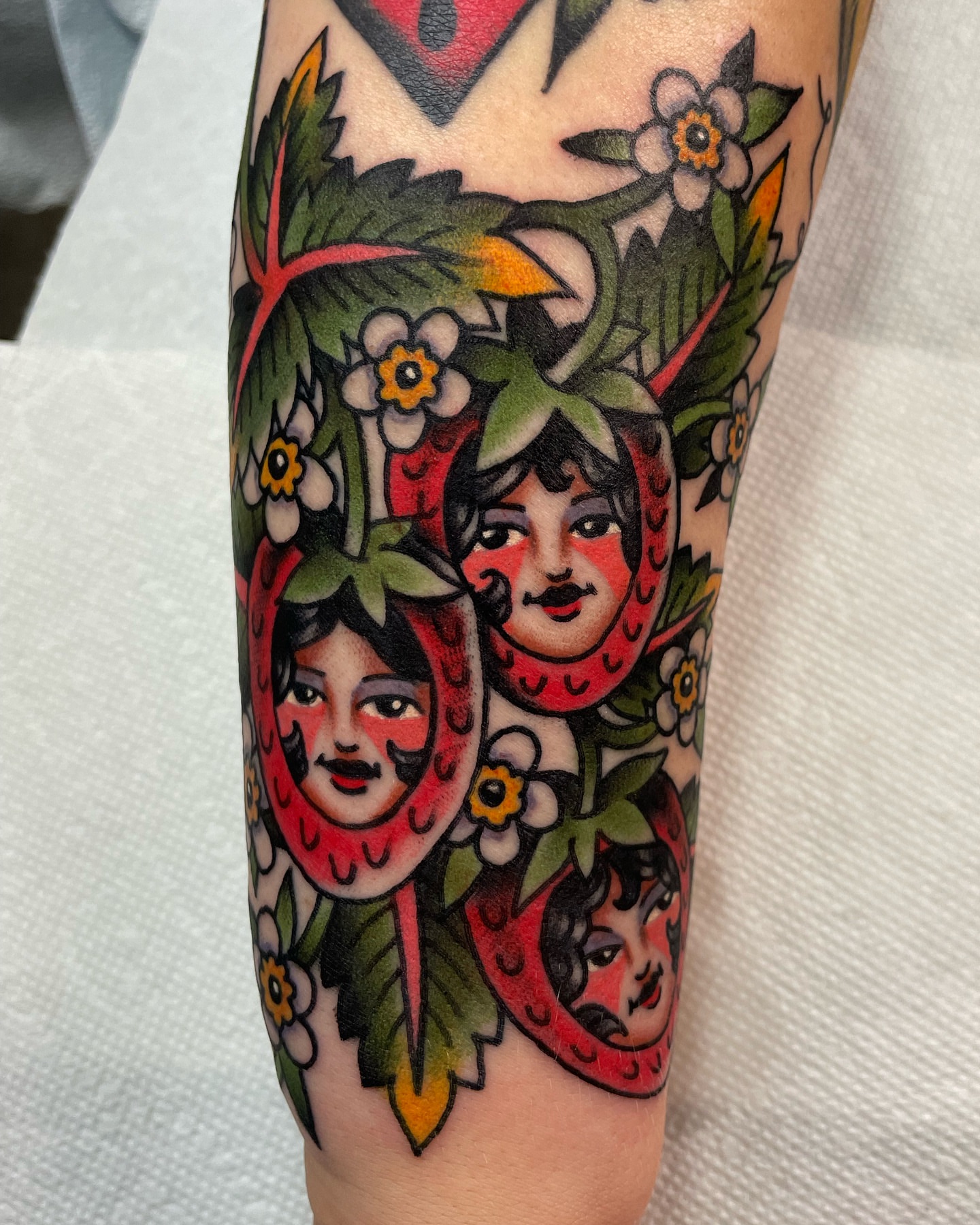 Strawberry faces American traditional tattoo on the forearm by derrick b. π² Modern Traditional Tattoo