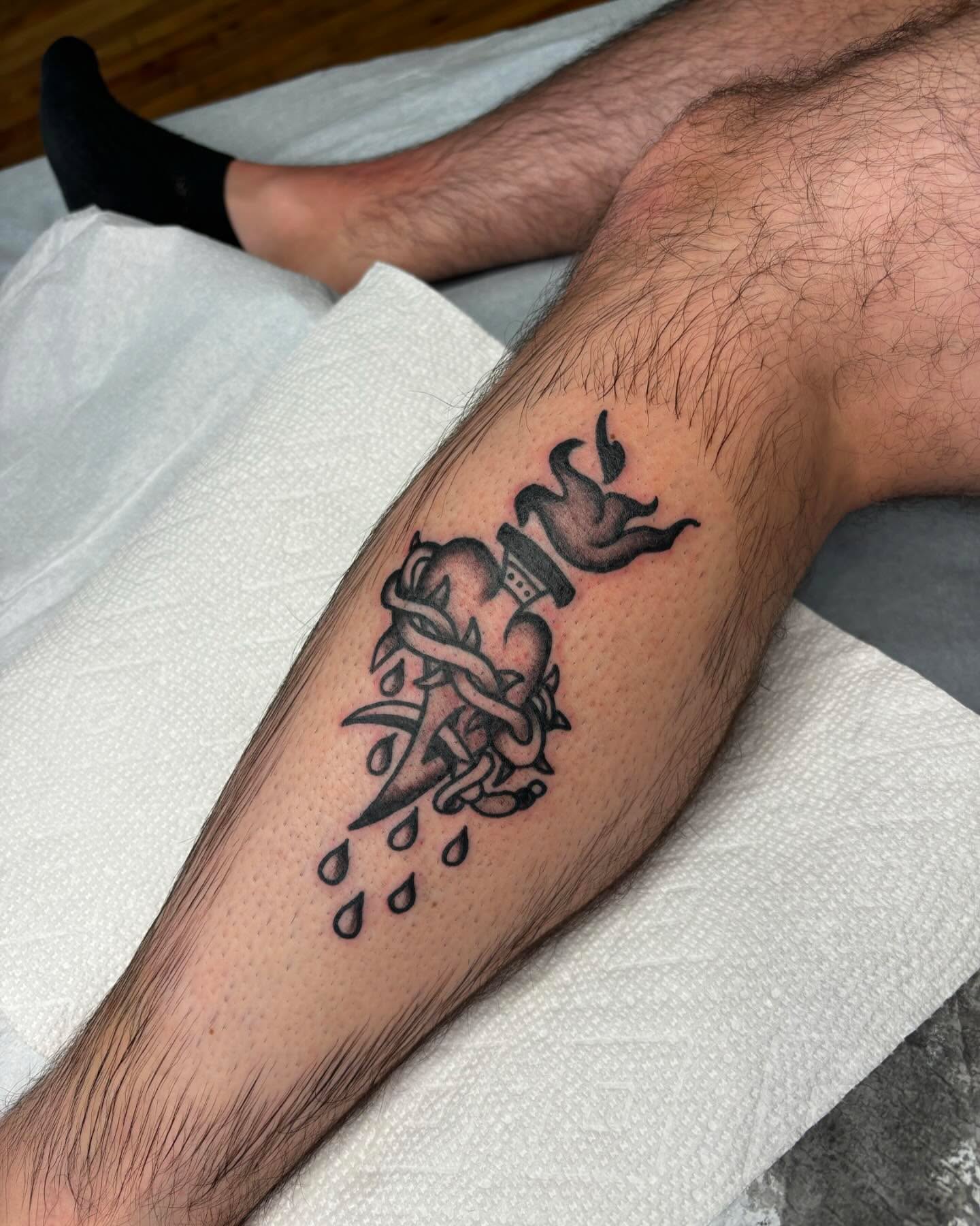 Flame and ribbon black and grey tattoo on the forearm by Emmy Gallagher