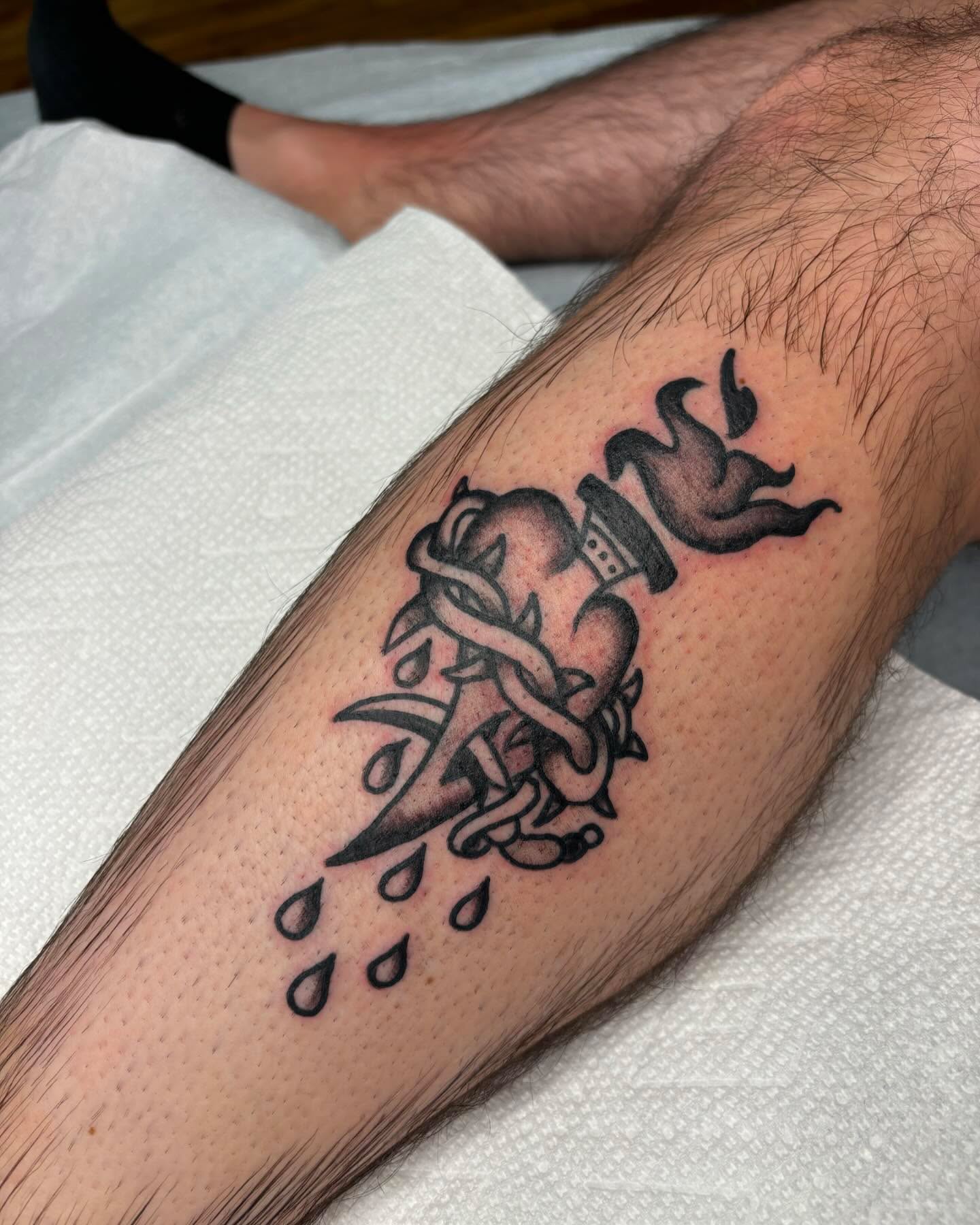 Rose and flame black and grey tattoo on the forearm by Emmy Gallagher