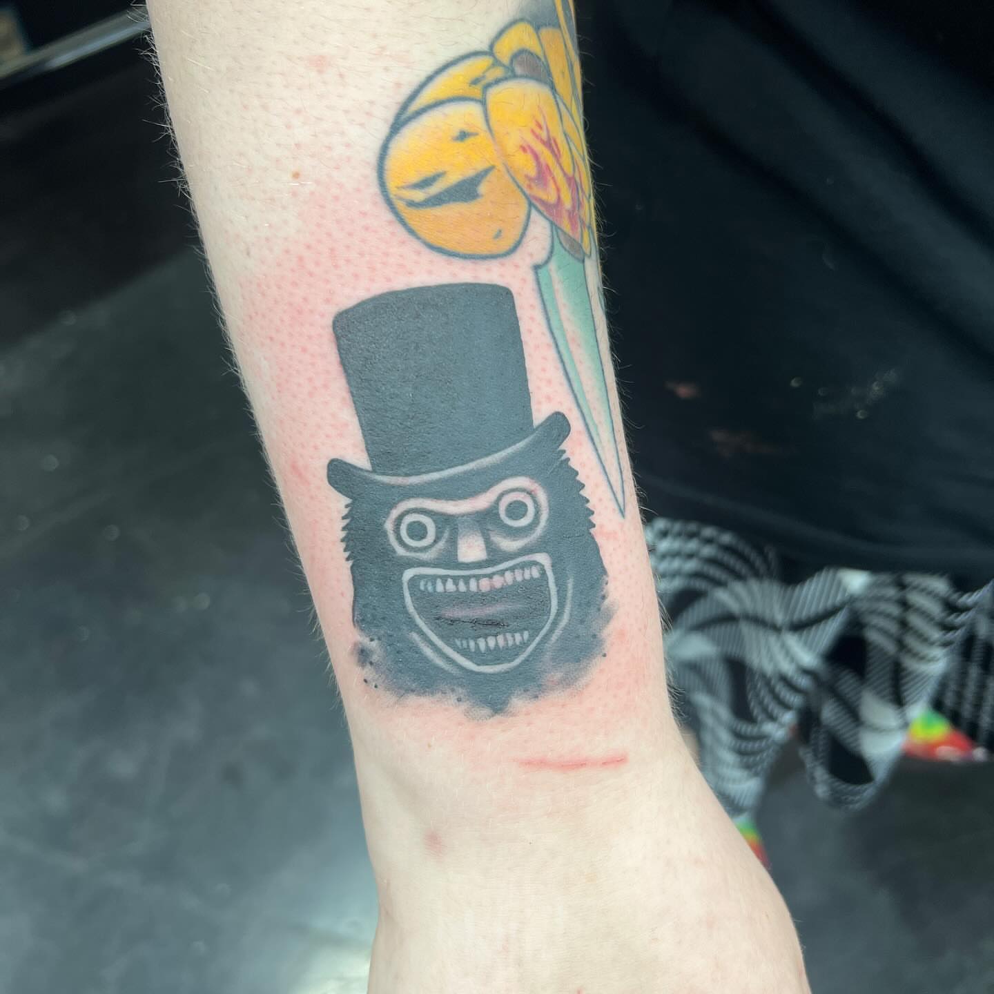 Top hat monster black and grey tattoo on the forearm by Hildur Blom, Seattle, Washington