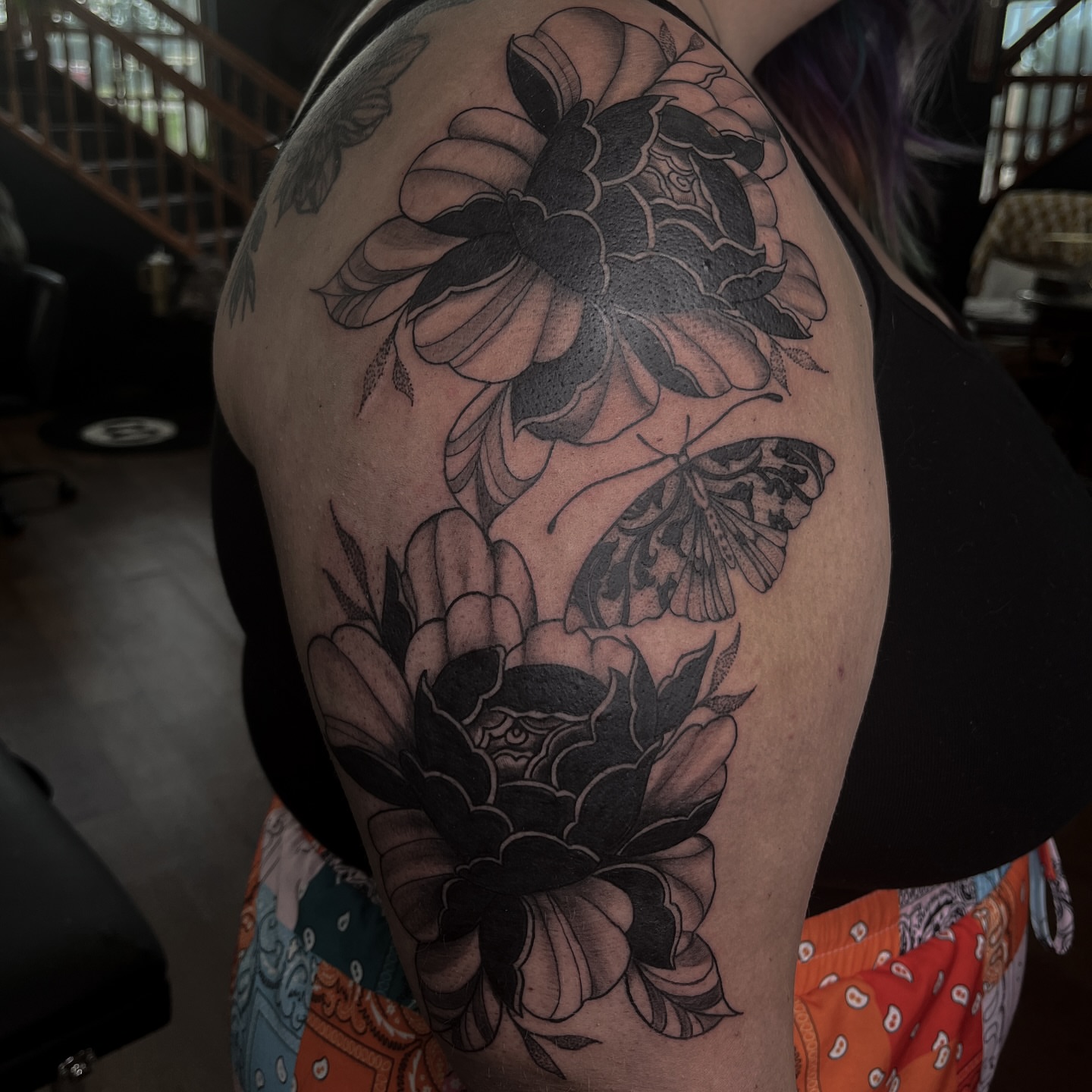 Flowers and butterflies black and grey tattoo on the shoulder by ⚜️Embodied Tattoo⚜️, Columbus, Ohio