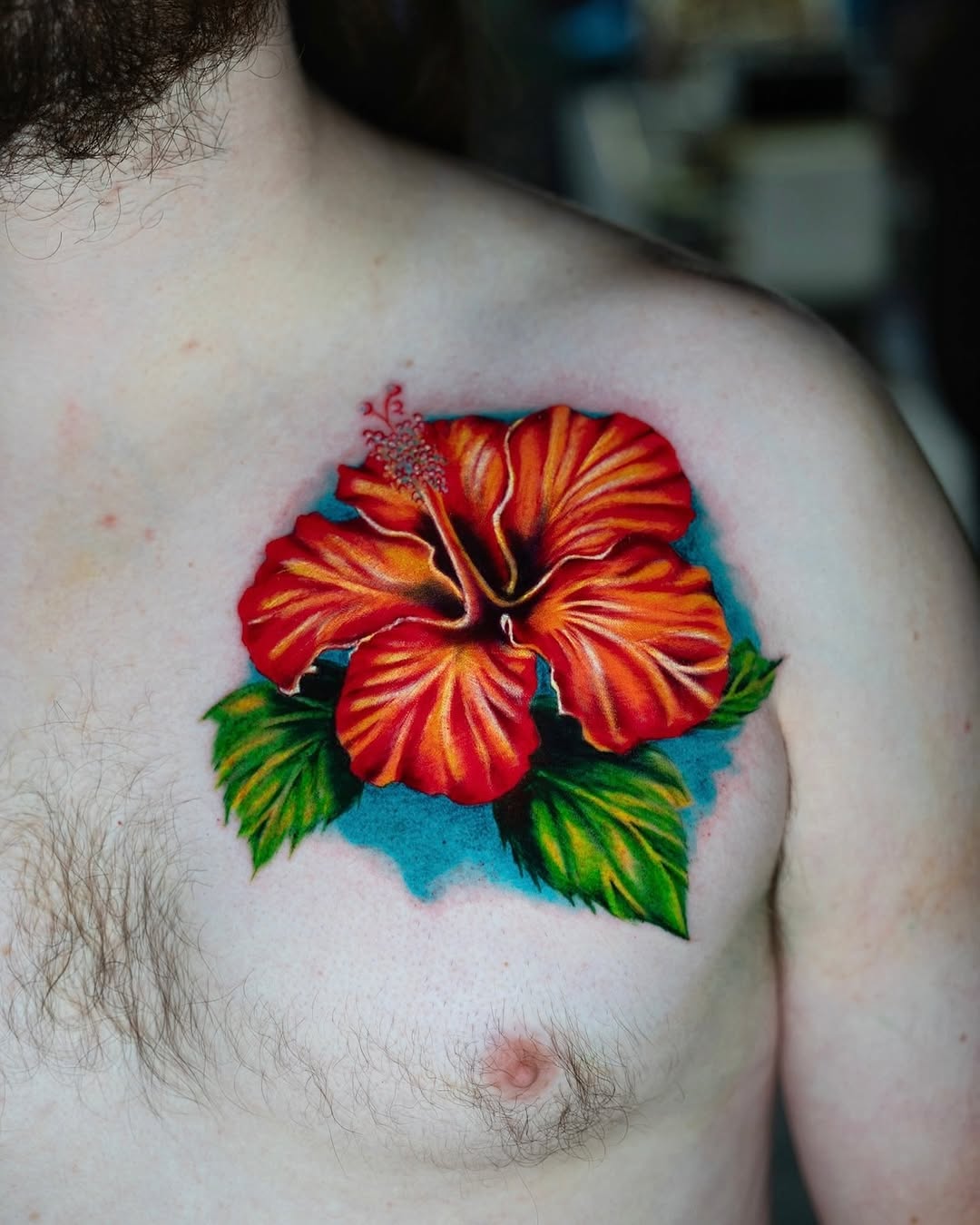 Hibiscus flower neo-traditional tattoo on the chest by Charlotte Tattoo Artist