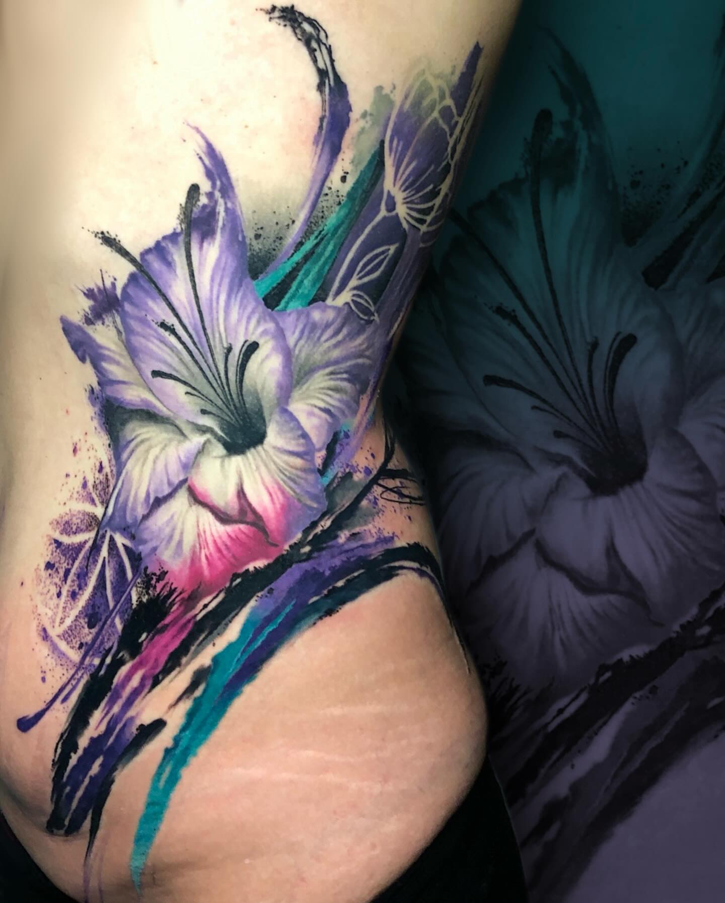 Flower watercolor tattoo on the upper arm by Mike Shultz