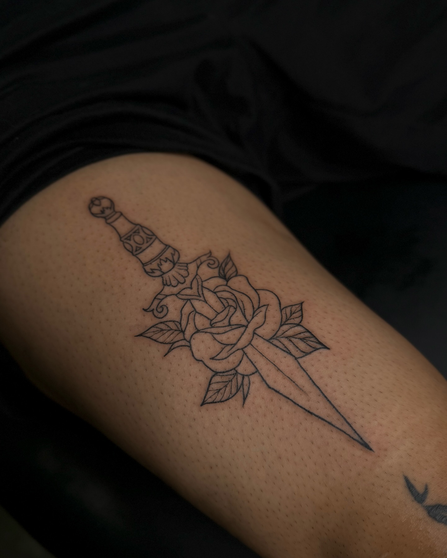 Sword and rose black and grey tattoo on the thigh by Dee, San Diego, California