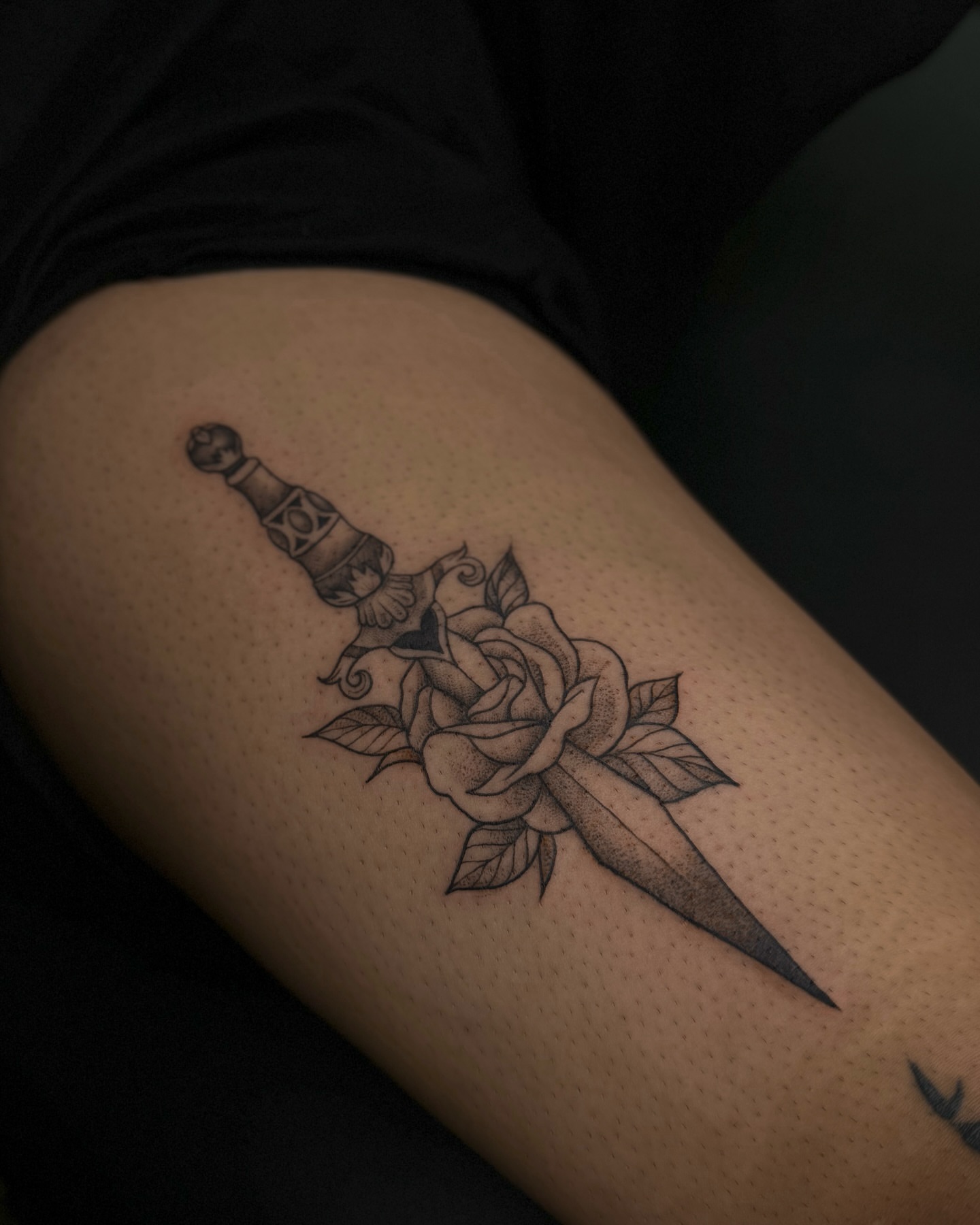 Sword and rose dotwork tattoo on the thigh by Dee, San Diego, California