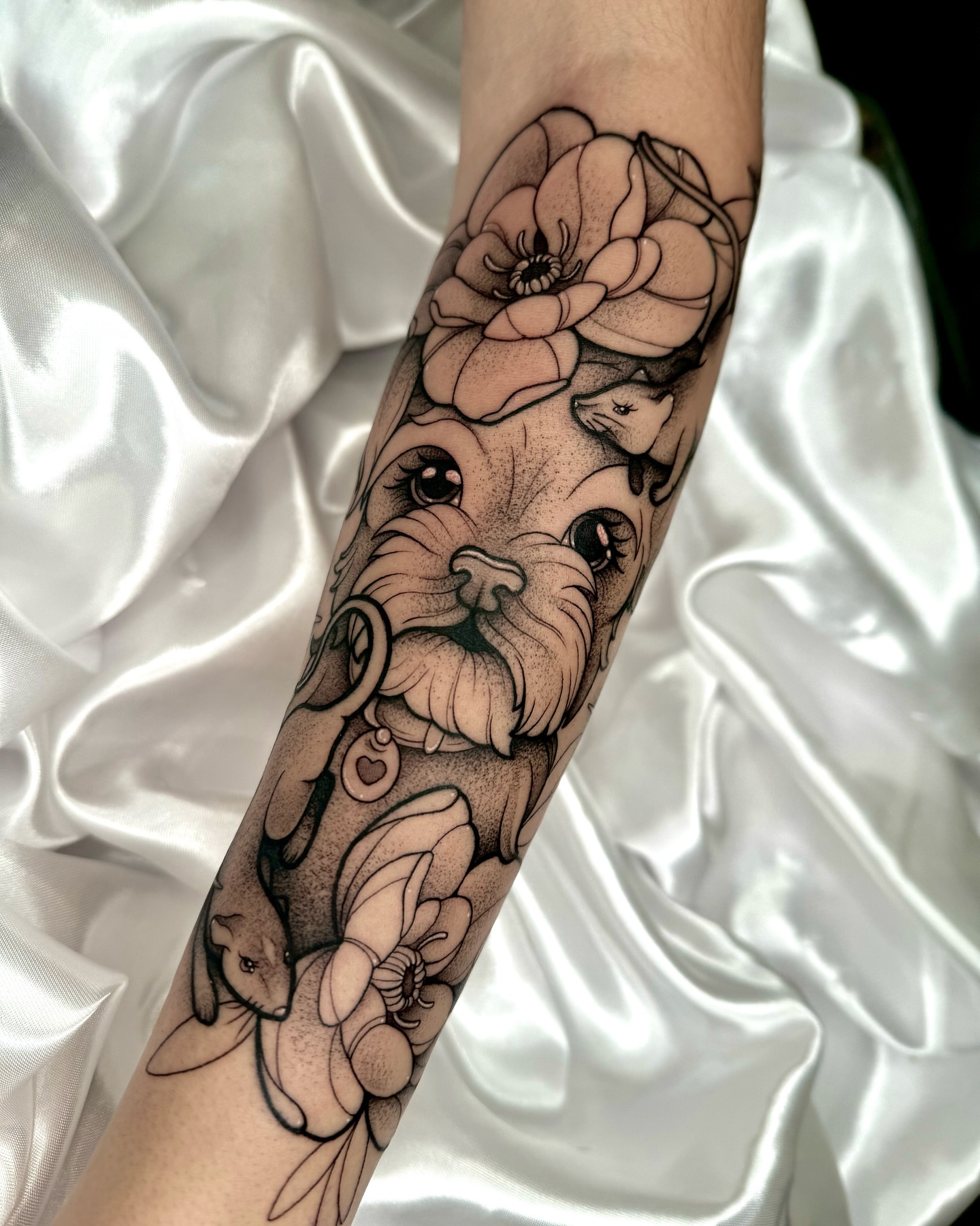 Dog with flowers realism tattoo on the forearm by Gabrieli Folha