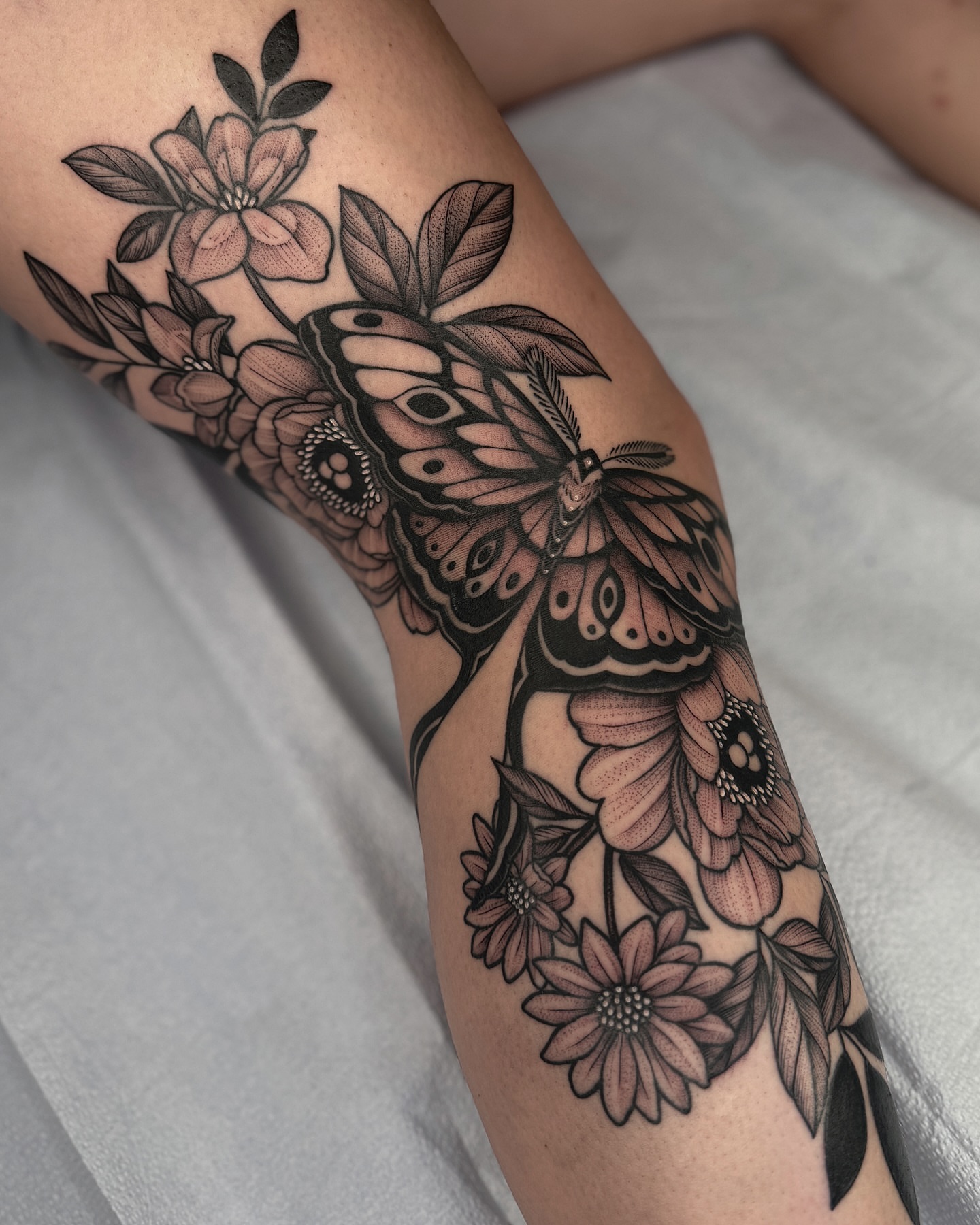 Butterfly and flowers realism tattoo on the forearm by Kyle Stacher - Blackwork Tattoos - Denver