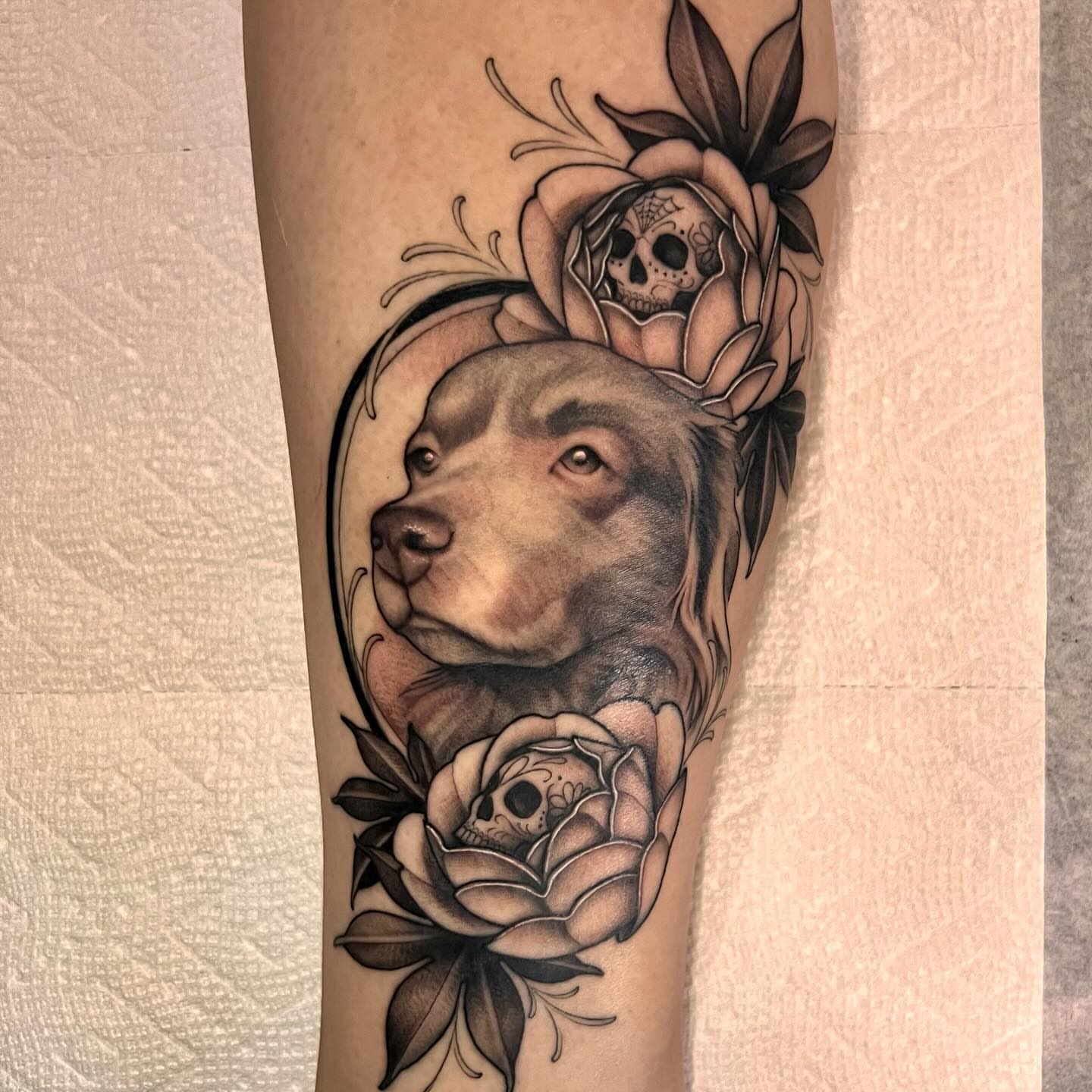 Dog and roses realism tattoo on the forearm by Chelsea Darling