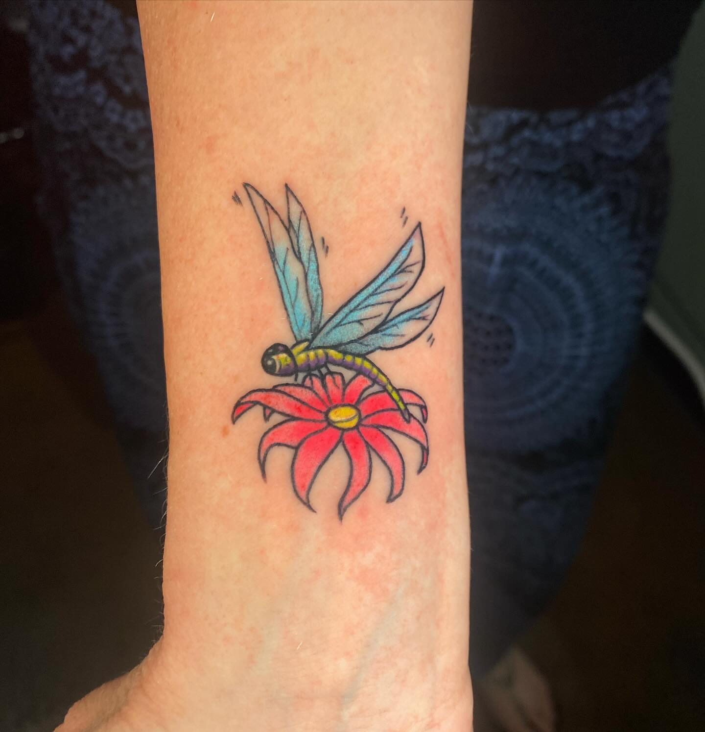 Dragonfly on flower new school tattoo on the forearm by Chelsey Moore, Albuquerque, New Mexico