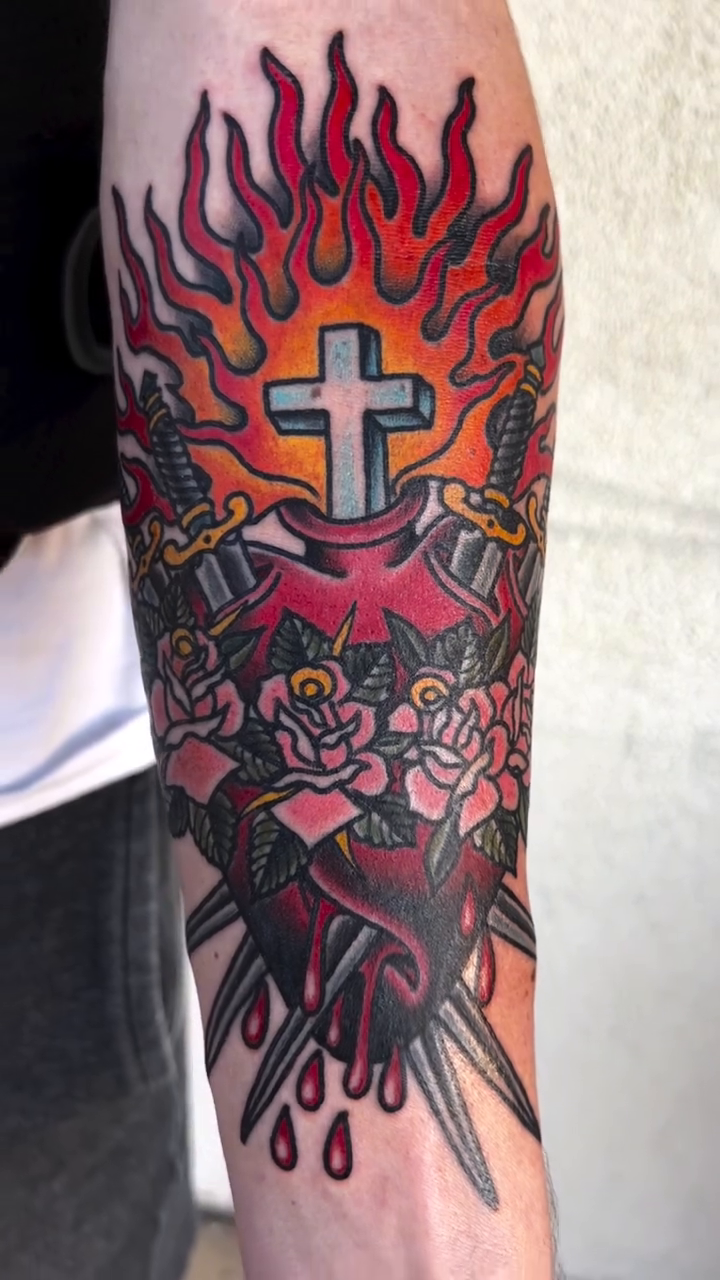 Sacred heart with cross and swords American traditional tattoo by Kayle Leogrande