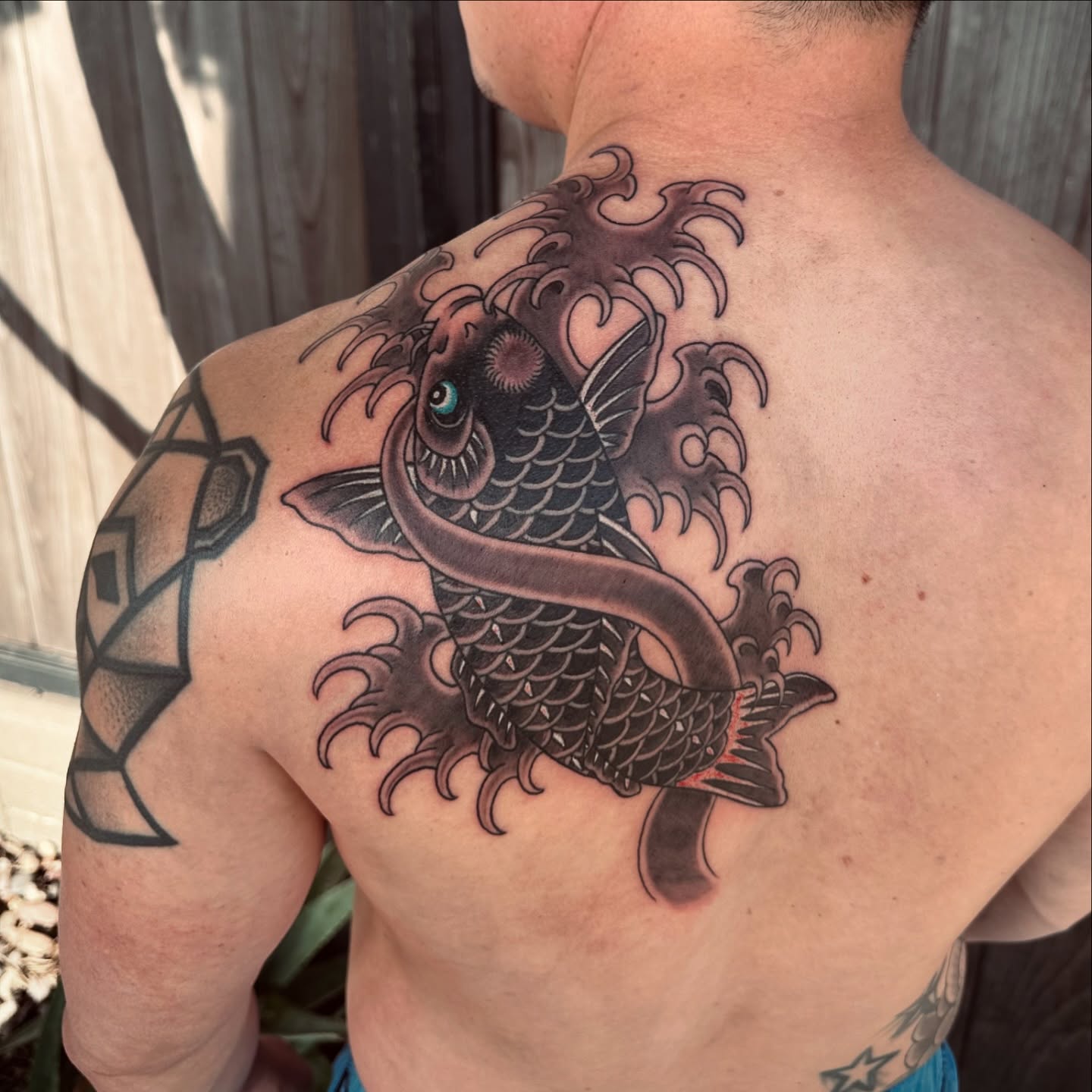 Koi fish japanese irezumi tattoo on the back by Kenny Waizumi ๐