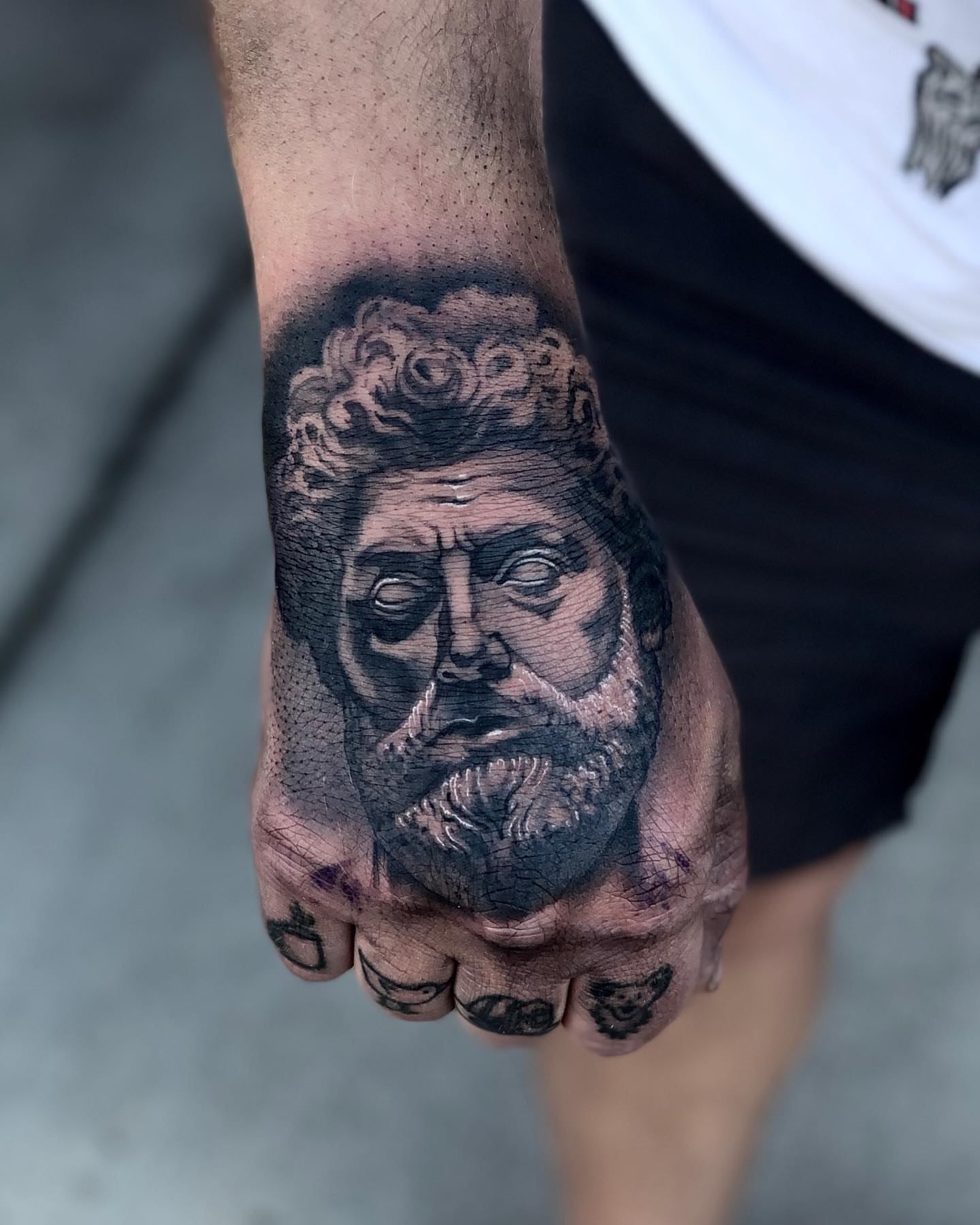 Portrait realism tattoo on the hand by Aaron Borden