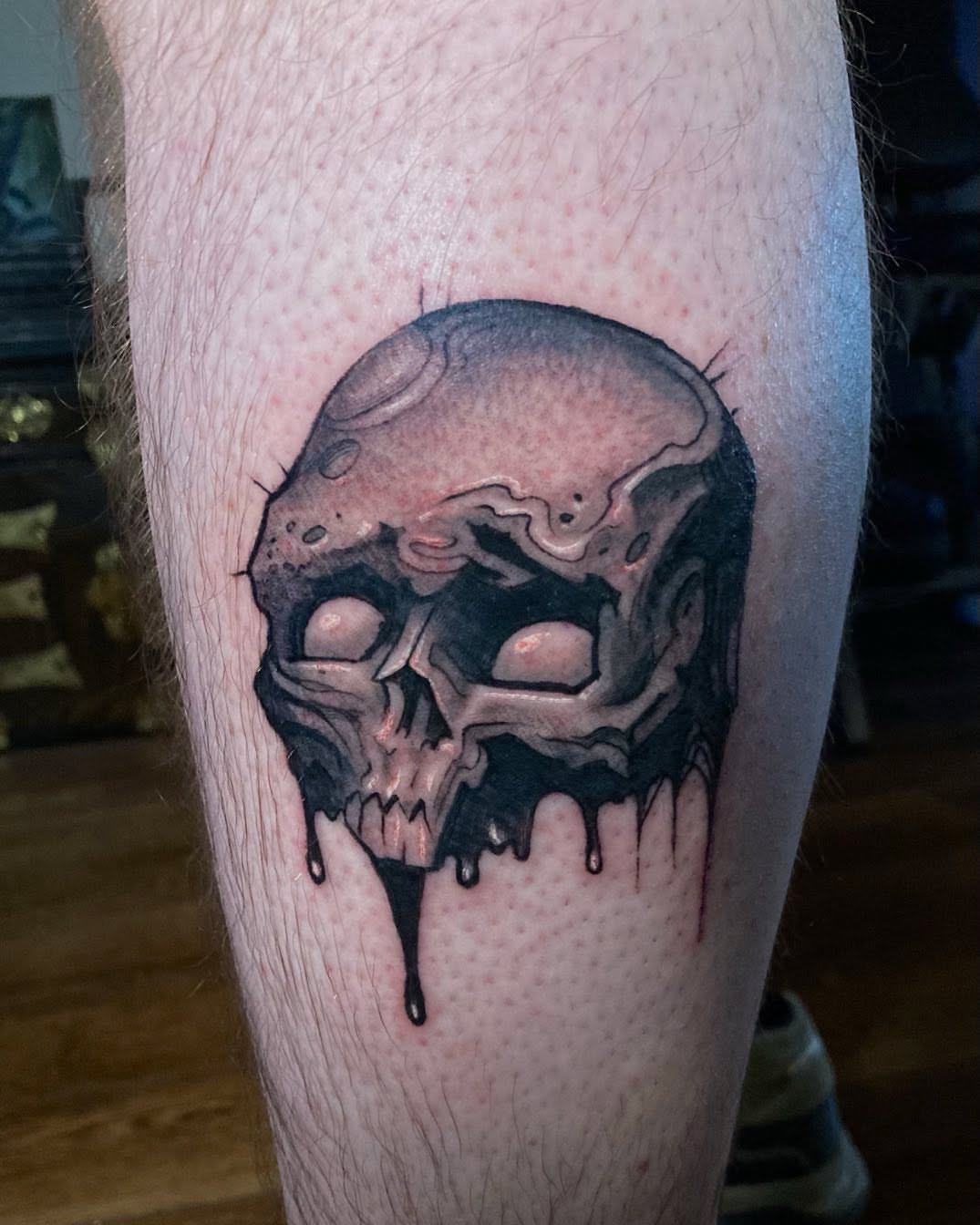 Melting skull dark realism tattoo on the forearm by Jason Wheelwright